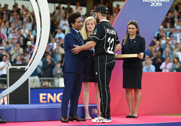 Kane Williamson is presented with his man of the tournament award by Sachin Tendulkar after the...