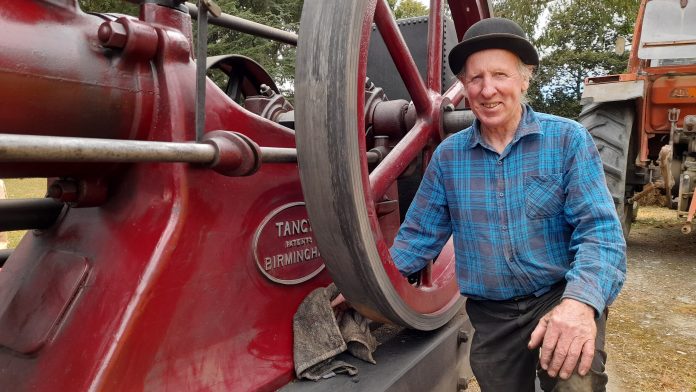 Peter Lynn shines up his stationary Tangye 1902 oil engine ready for the auction. Photo Toni...