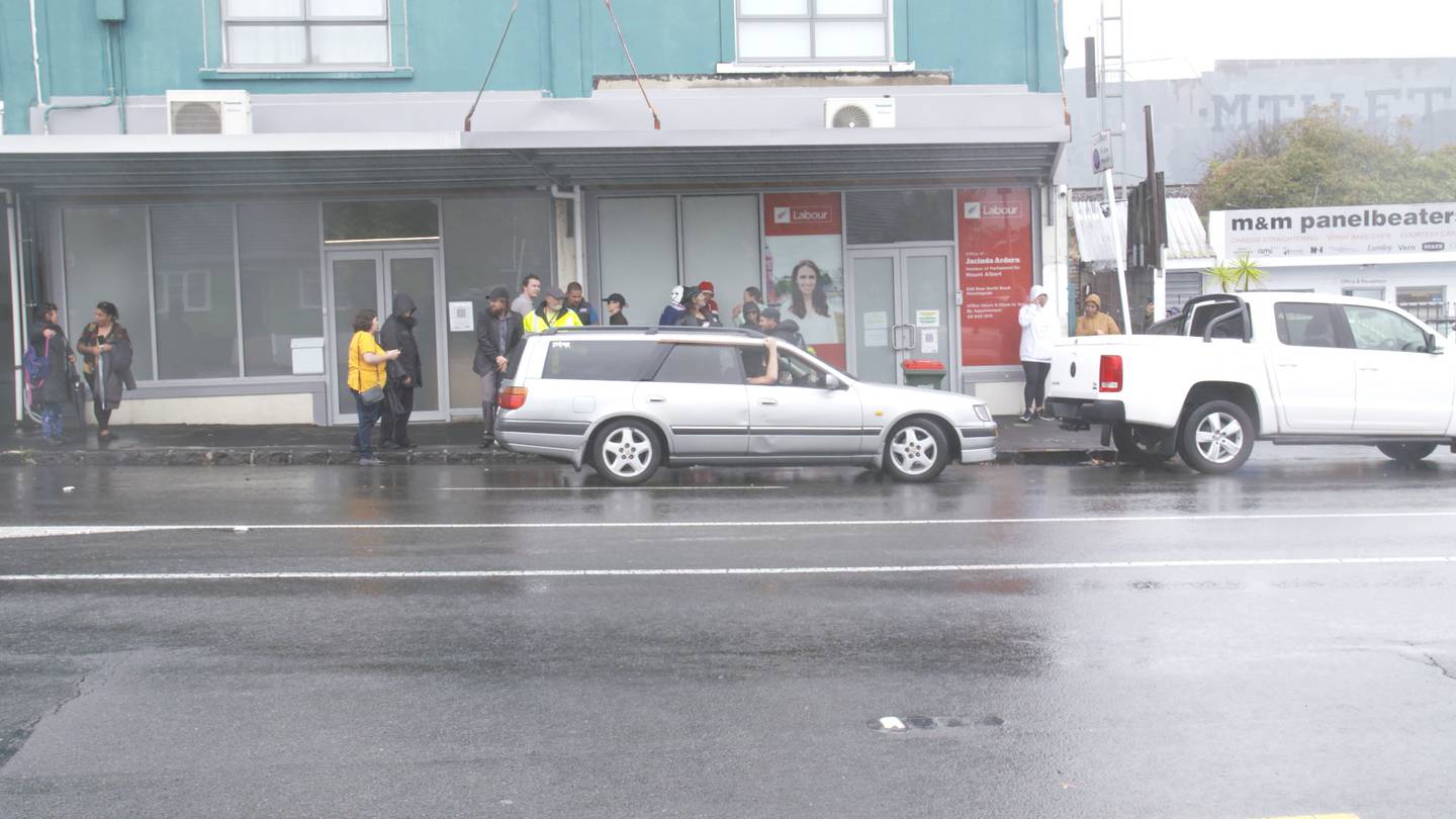 Anti-lockdown protestors gather outside Prime Minister Jacinda Ardern's vacant electorate office...