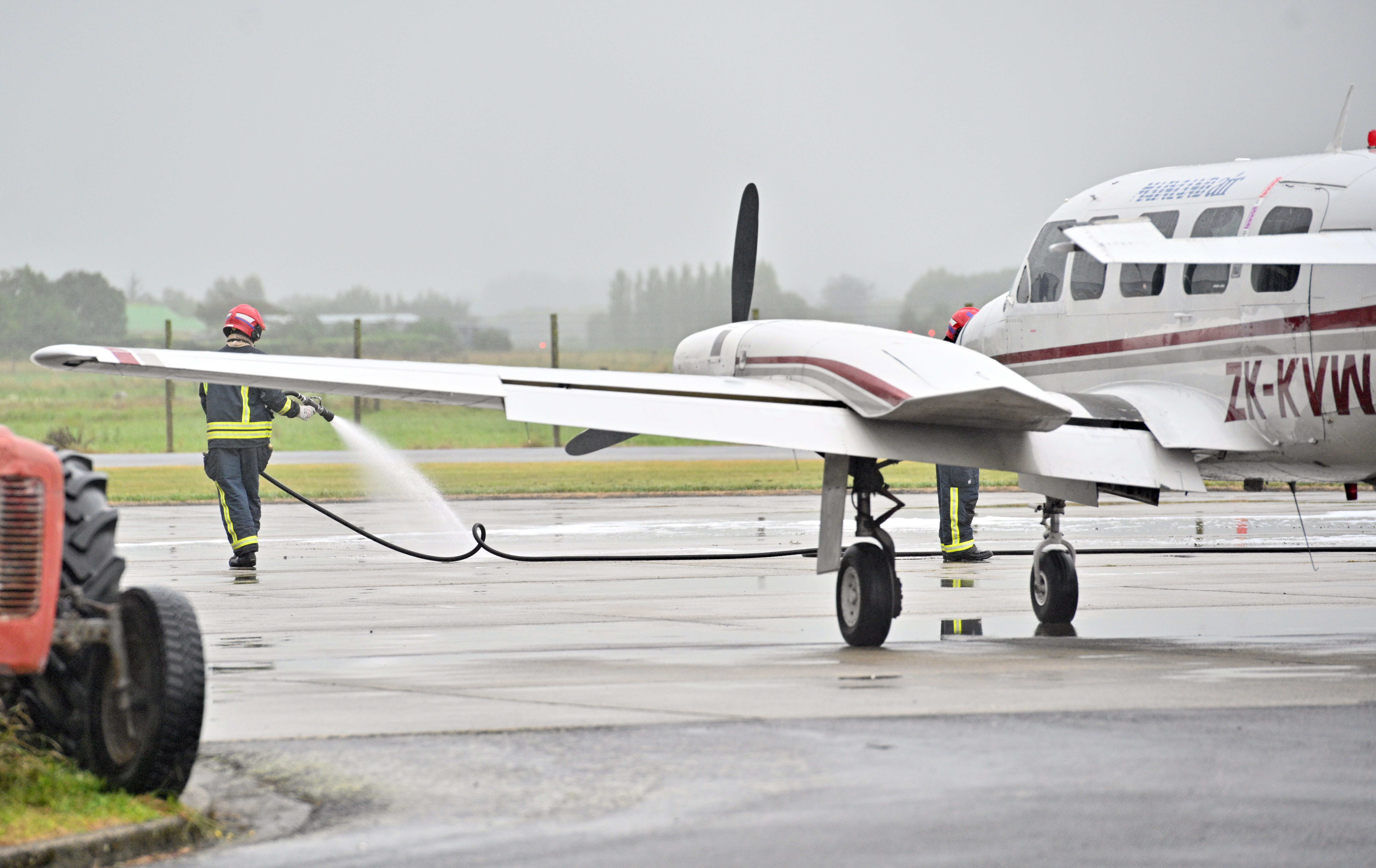 Service crew at Dunedin Airport attend the Piper Chieftain which had an engine stop in mid-air...