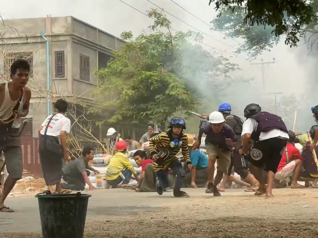 Protesters take cover during clashes with security forces in Monywa, Myanmar, earlier this week....