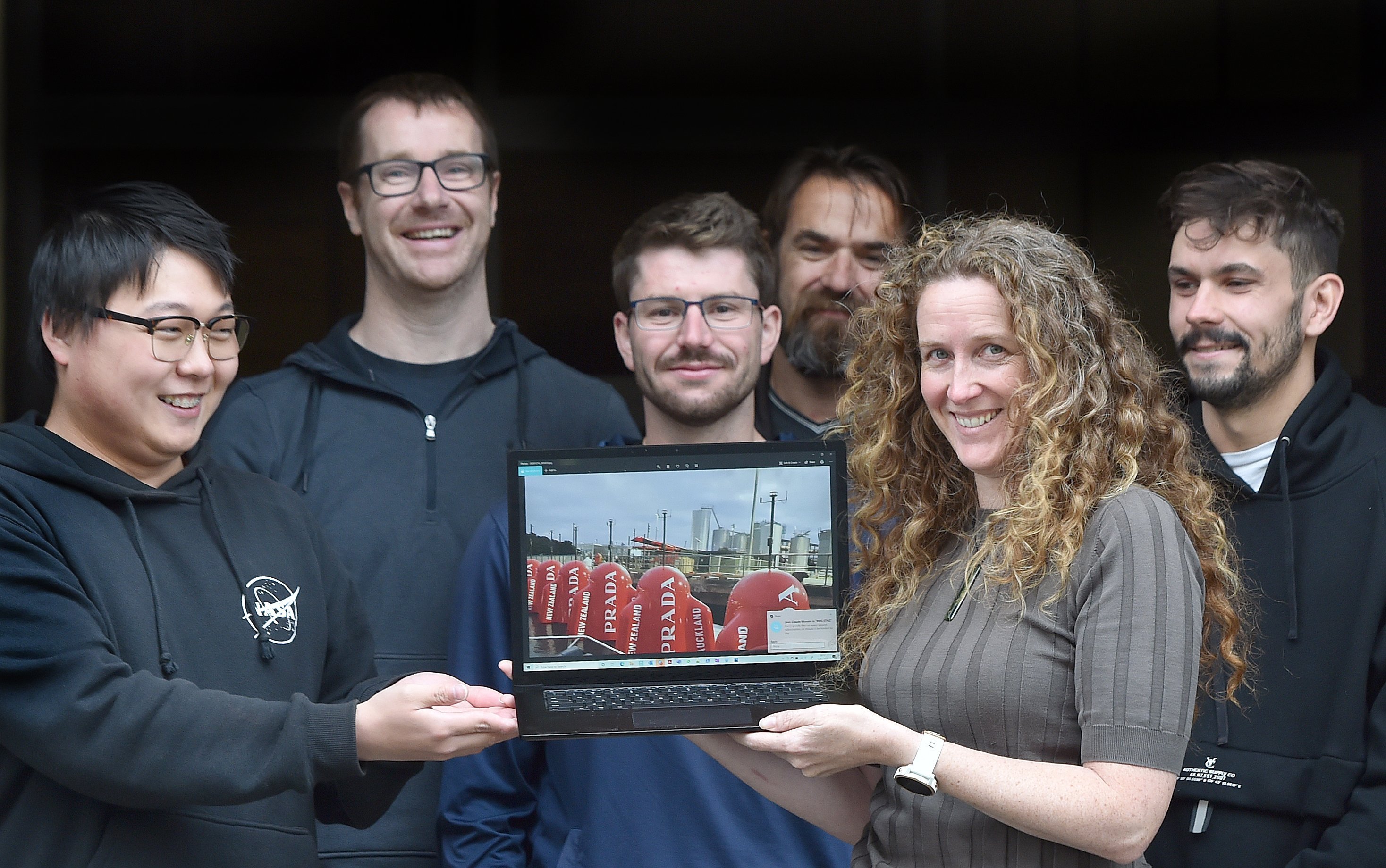 Igtimi general manager Kylie Robinson holds an image of America's Cup race markers featuring...