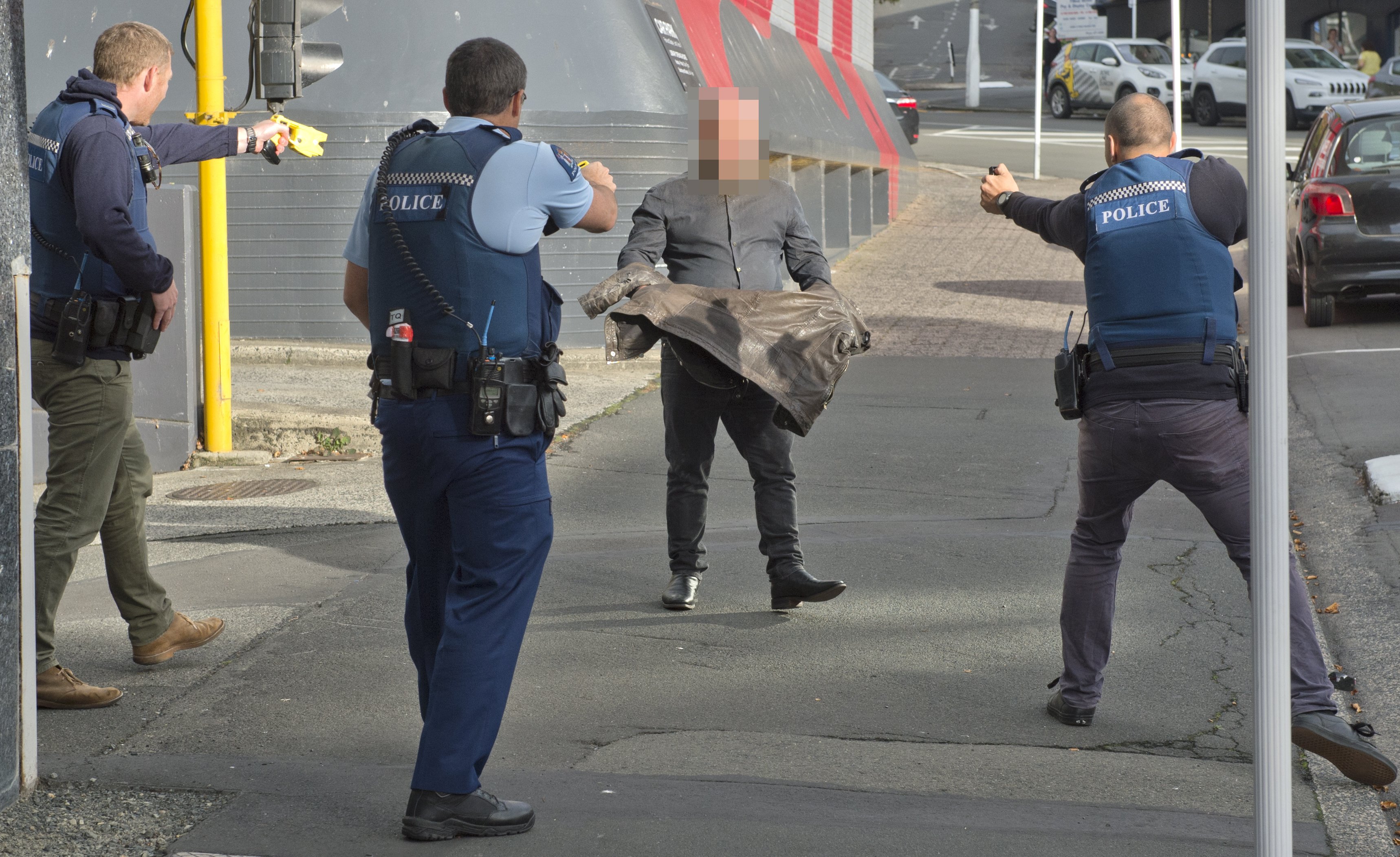 A man is subdued by police armed with Tasers and a firearm after he smashed up the Dunedin City...