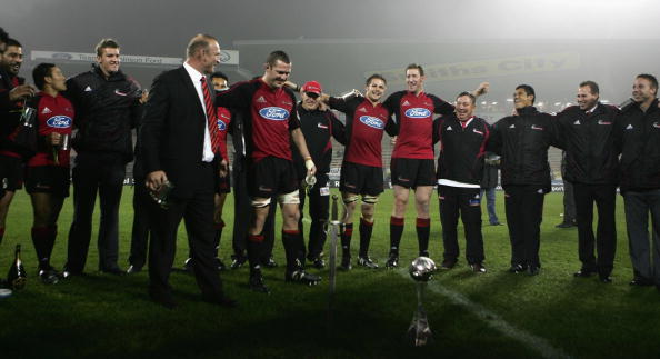 Verne Cotter (left) and Reuben Thorne plant the Crusaders sword next to the trophy following the...