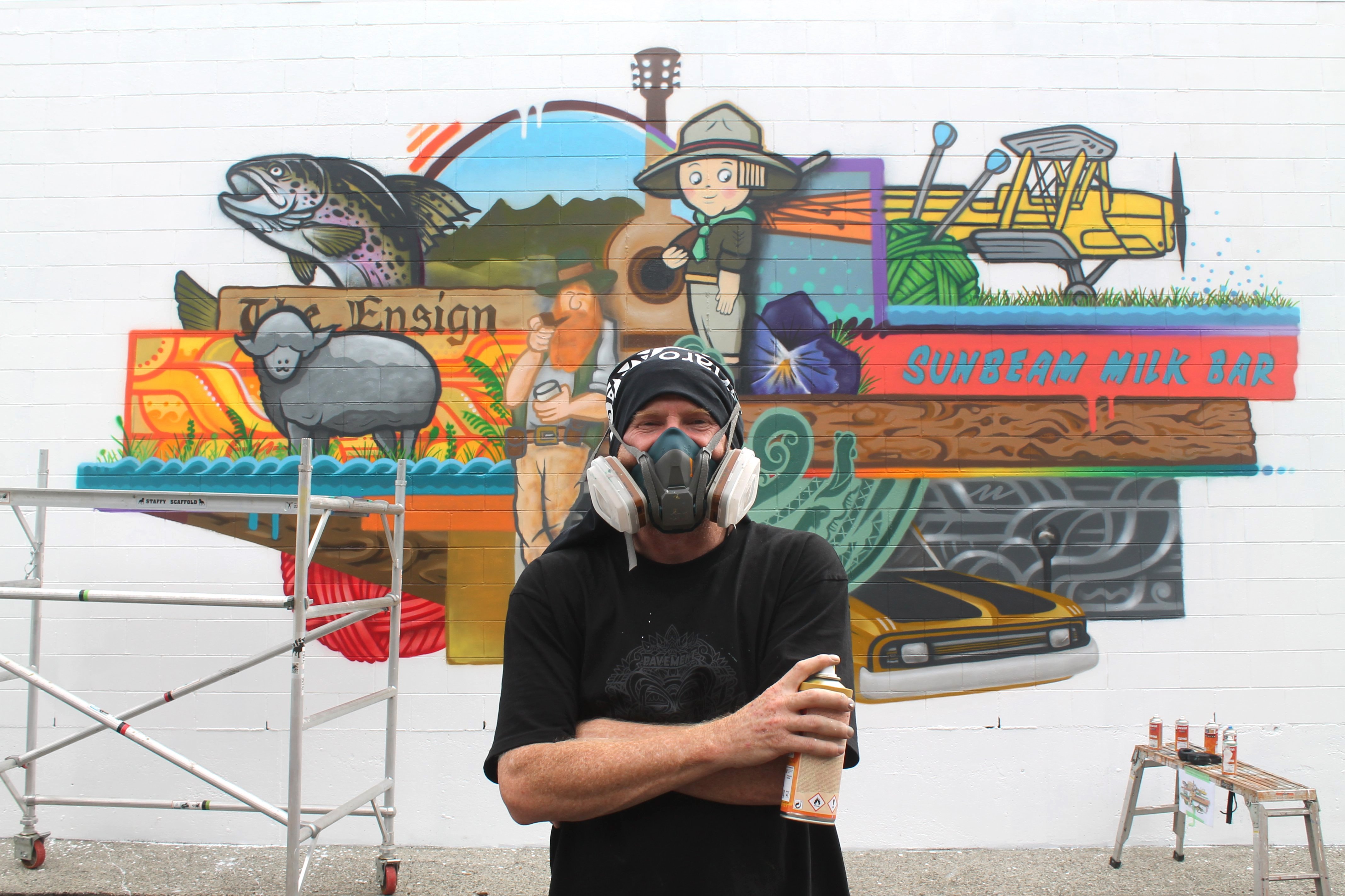 Artist Sean Duffell takes a quick break while apply the finishing touches to his Tower Lane mural...