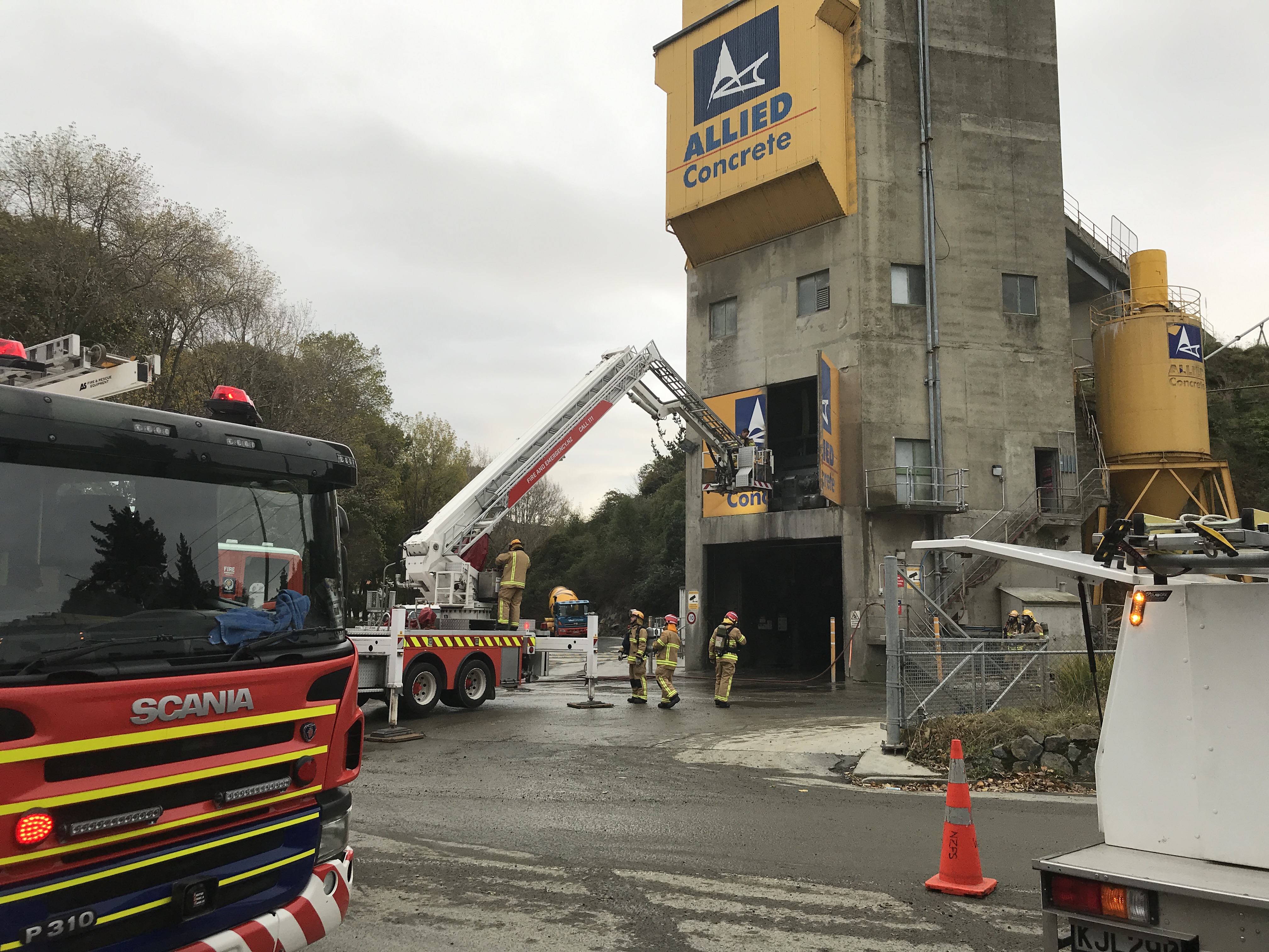 Fire crews attend to a fire in the mixing room at Allied Concrete this morning. Photo: Gregor Richardson