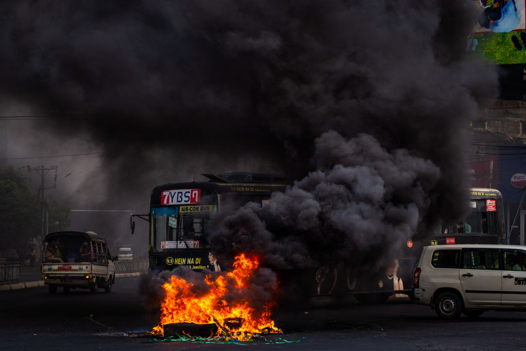 Smoke rises from tyres set alight by anti-coup protesters in Yangon earlier this month. Hundreds...