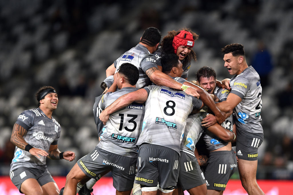 Chiefs players mob Damian McKenzie after his golden point penalty won the game. Photo: Getty Images