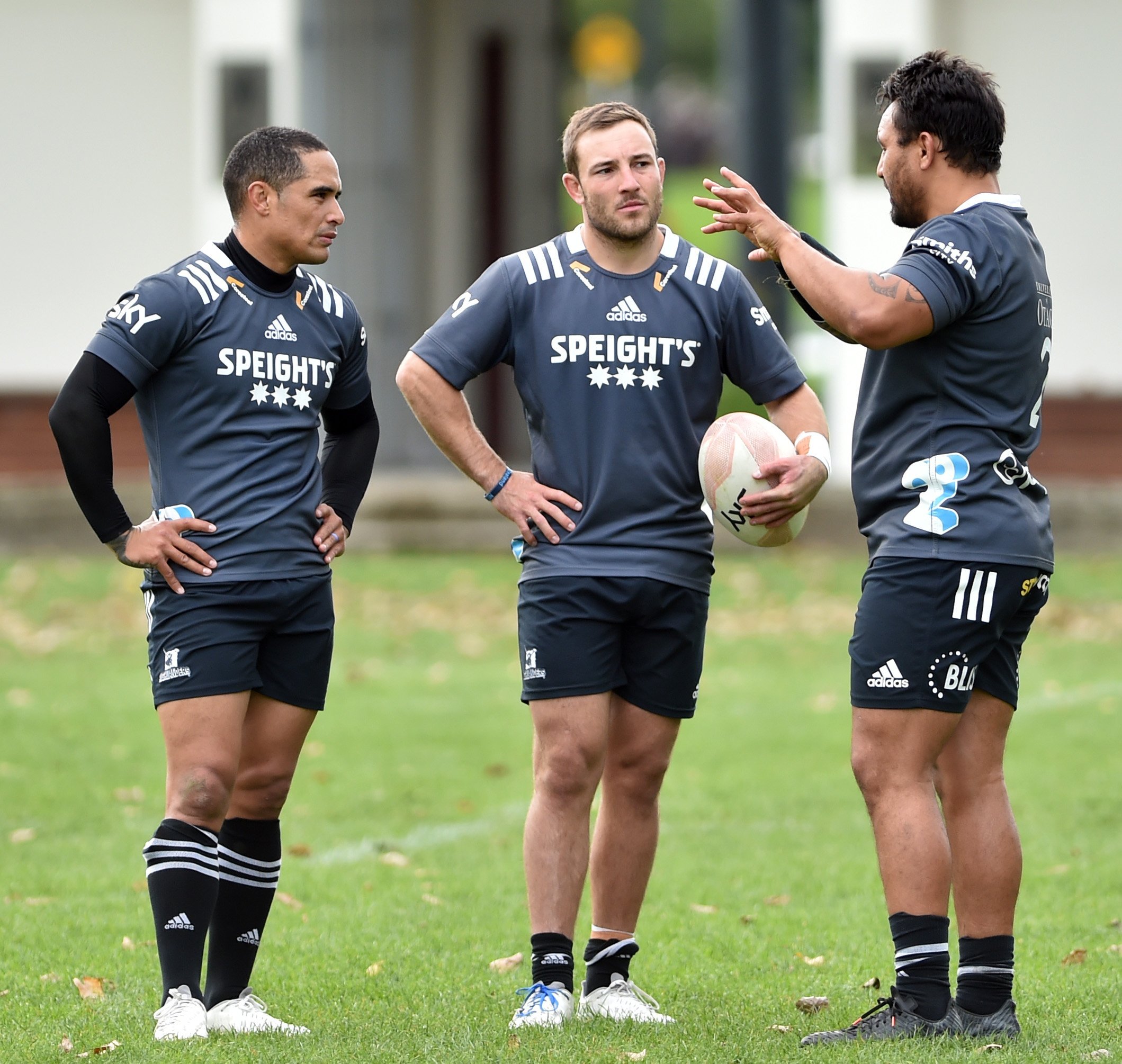 Highlanders (from left) Aaron Smith, Mitch Hunt and Ash Dixon meet during training at Logan Park...