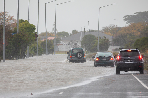 Vehicles drive through flood waters in Christchurch. Photo: Sanka Vidanagama / NurPhoto via Getty...