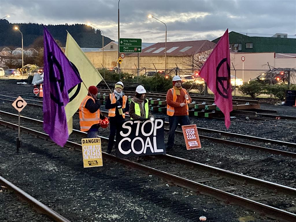 Protesters on the tracks at Dunedin Railway Station this morning. Photo: Stephen Jaquiery