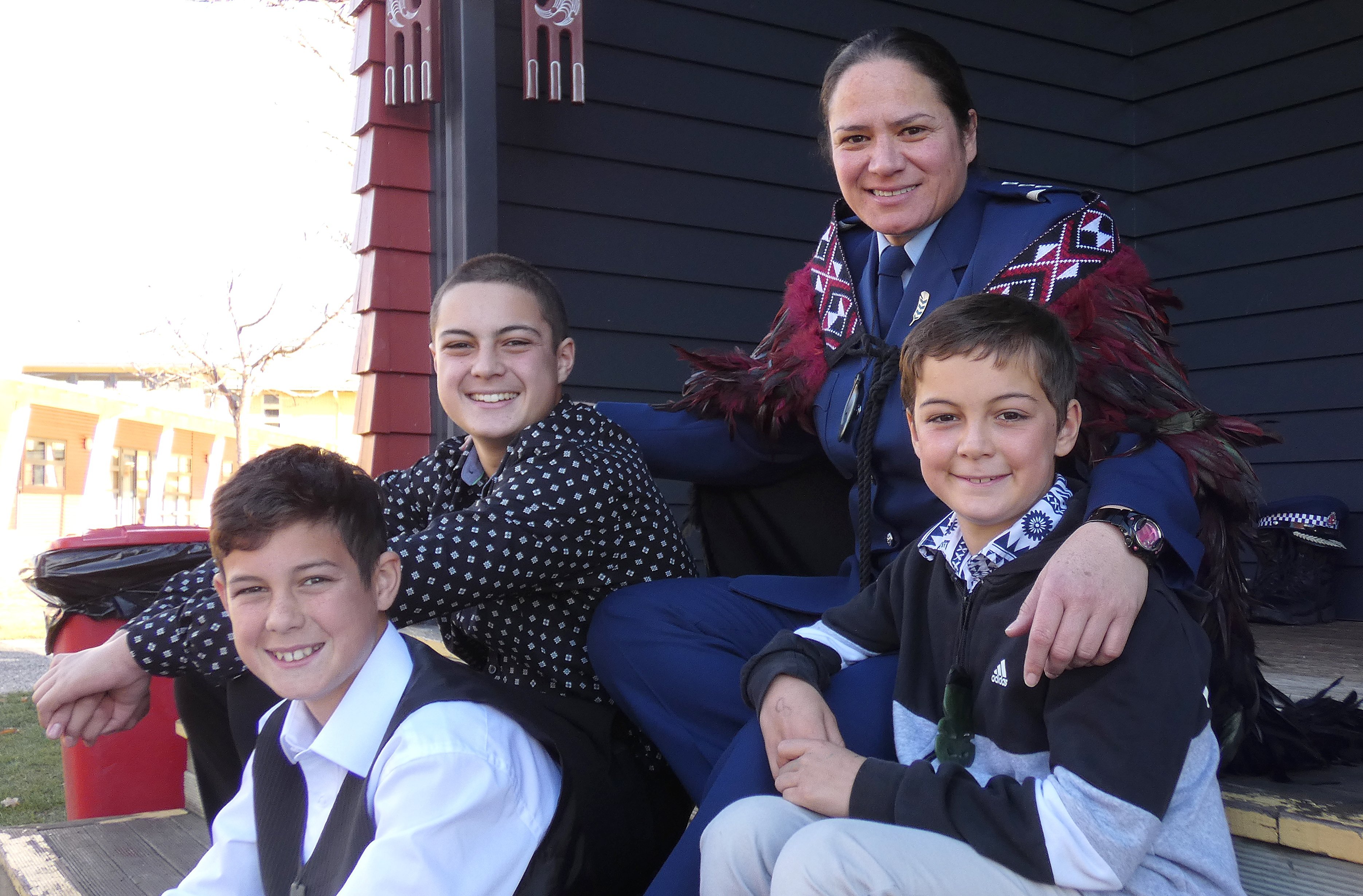 Inspector Paula Enoka shares a moment with her nephews (from left) Cory (12), Ryan (13) and Jared...