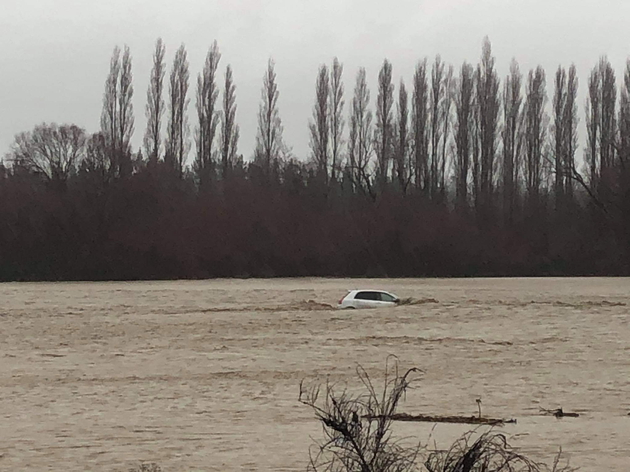 The occupants of this car managed to get out before the vehicle floated down Taylors Stream in...