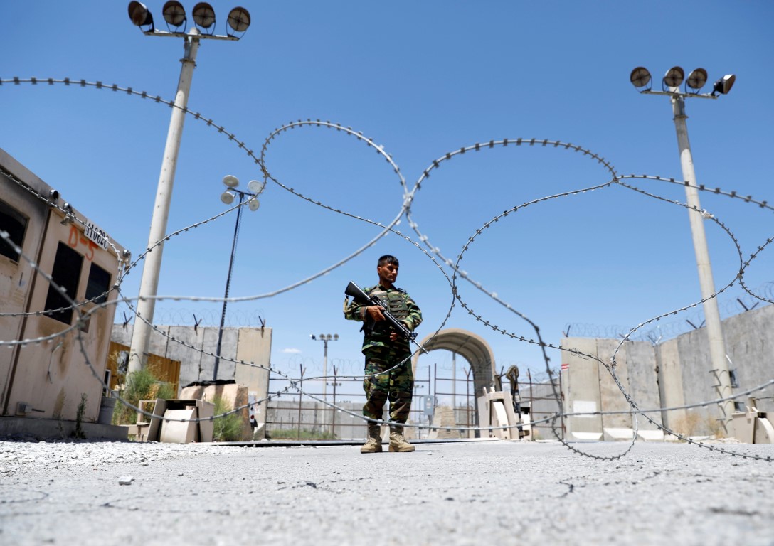 An Afghan soldier stands guard at the gate of Bagram US air base. Photo: Reuters