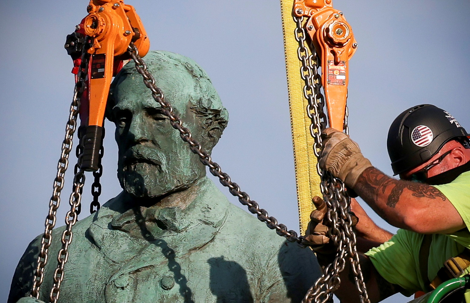 Workers remove the statue of Confederate General Robert E. Lee after years of legal battle. Photo...