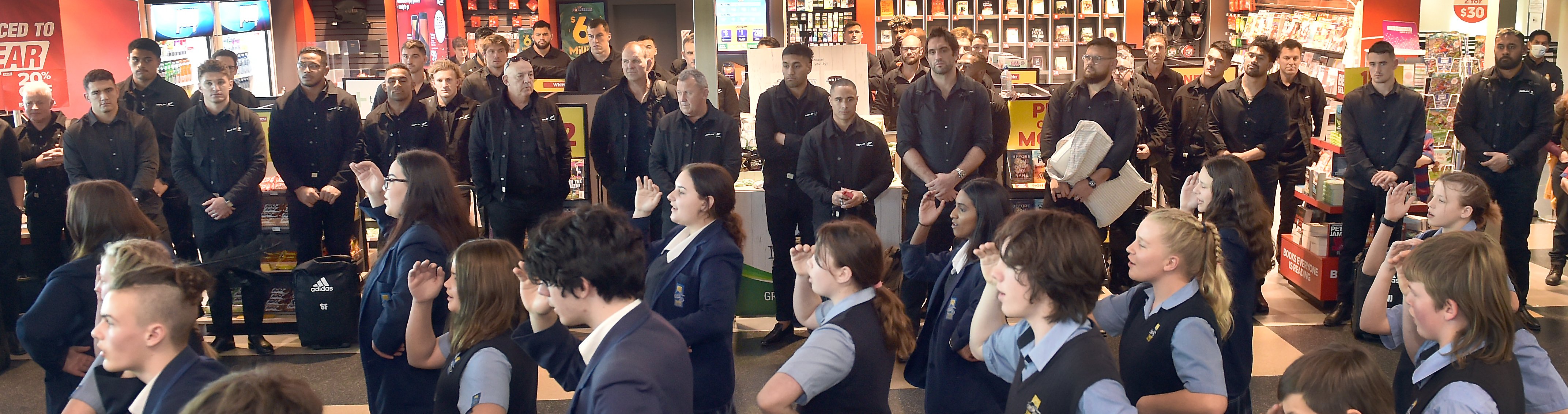 The All Blacks watch as they are welcomed by the Taieri College kapa haka group at Dunedin...