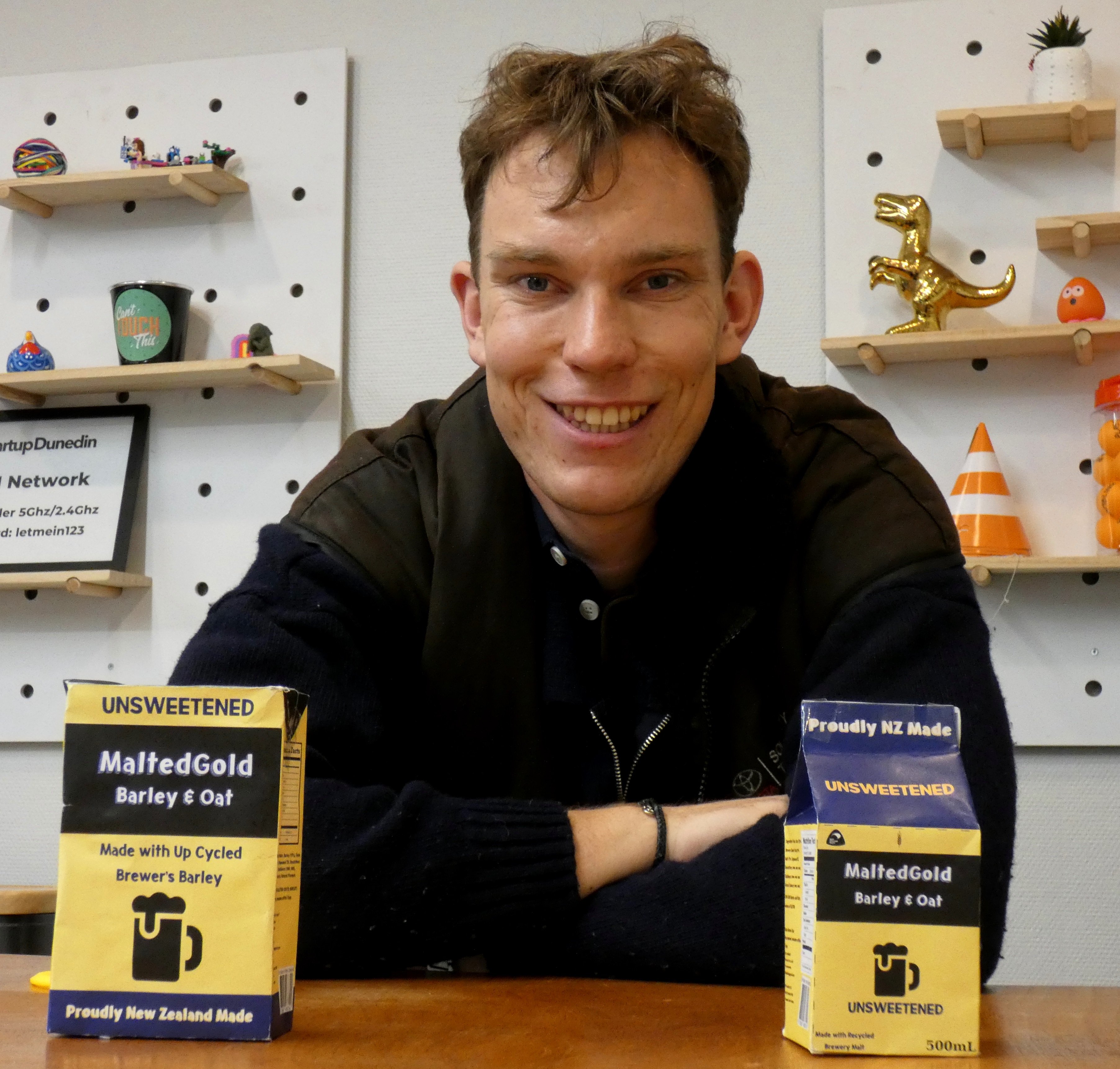 Malted Gold founder Ethan Bowmar shows packaging prototypes of his barley and oat milk product...