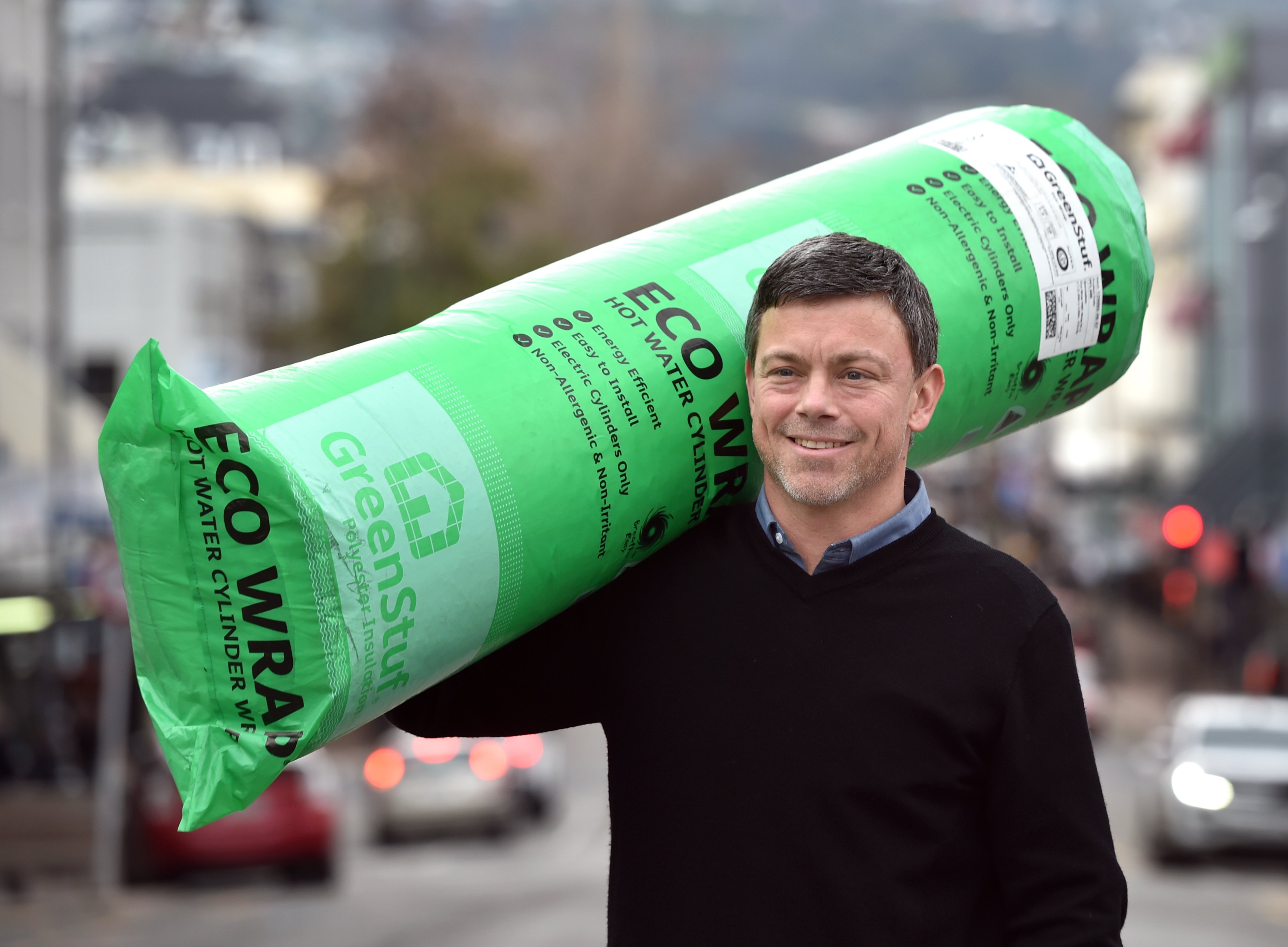 Carrying a pack of hot water cylinder wrap is Cosy Homes Charitable Trust executive officer...