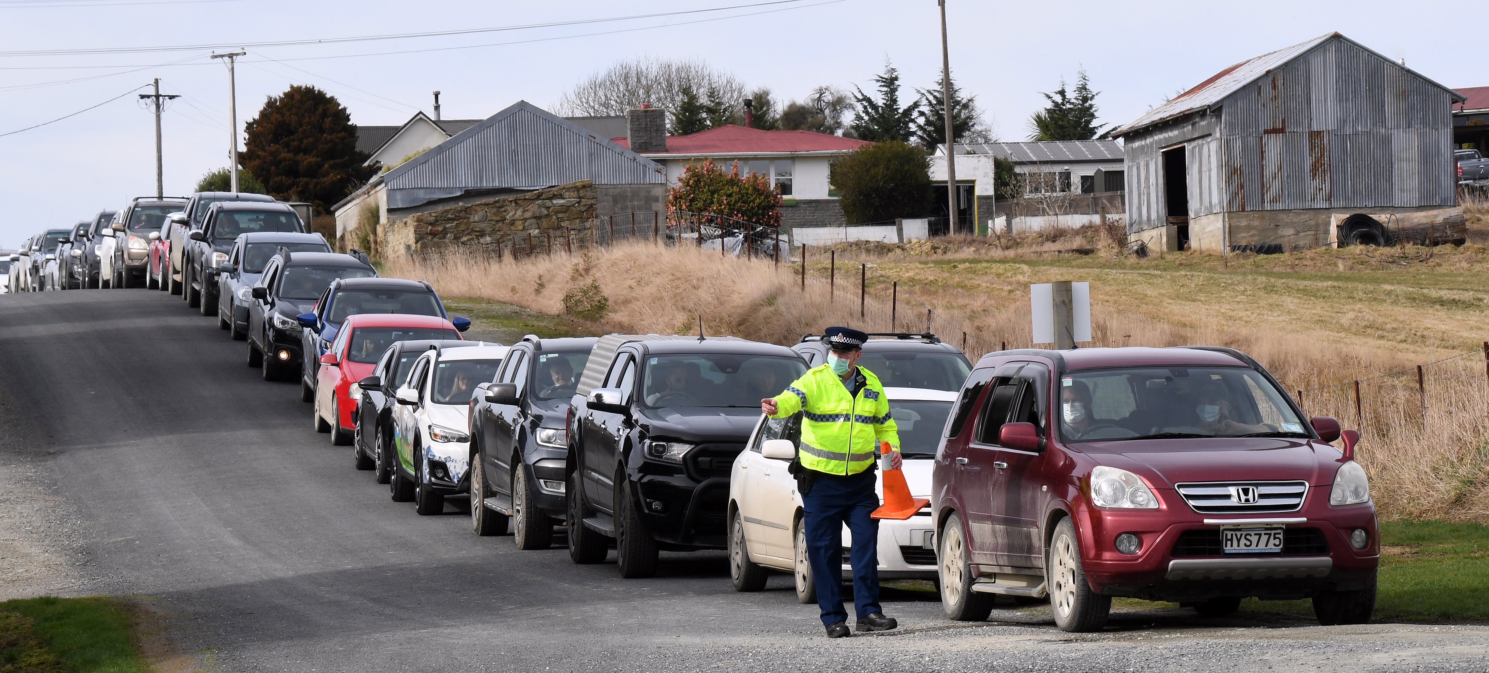 Constable Paul Alden, of Lawrence, marshals vehicles queuing at the entrance to the town’s...