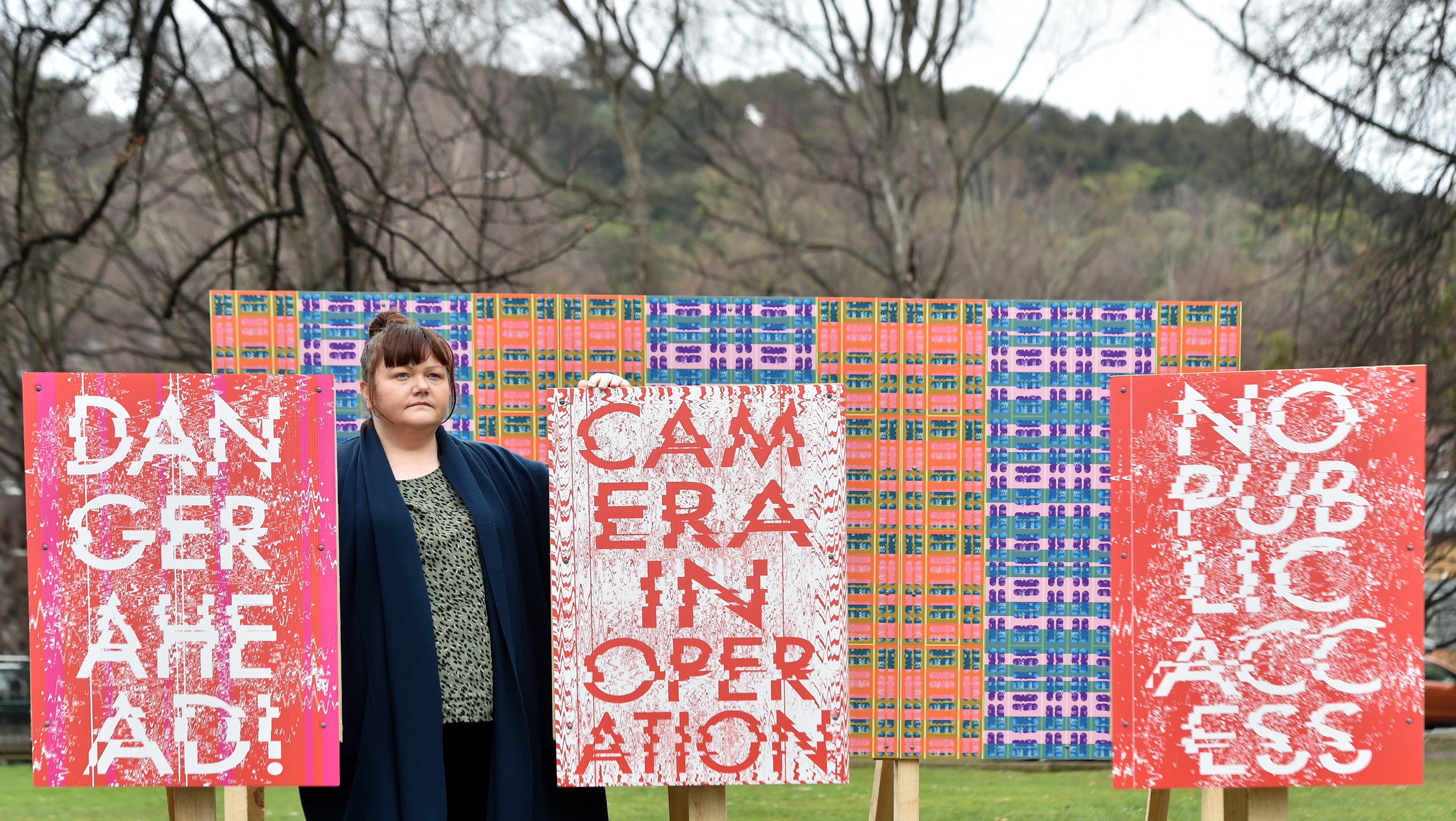 Artist Maggie Covell with her Billboard Wallpaper at the Otago Museum Reserve. PHOTO: PETER MCINTOSH