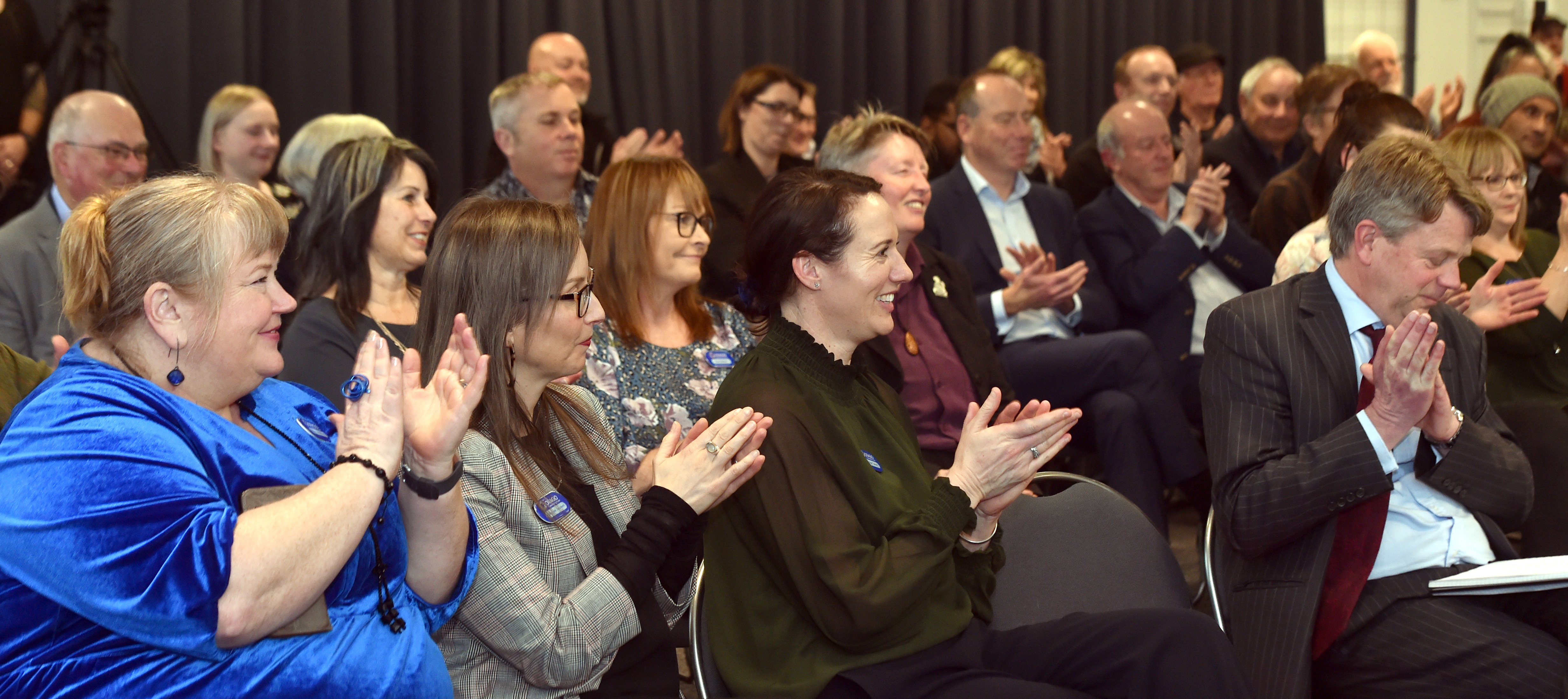 People applaud as Otago Community Trust chairman Diccon Sim (below right) addresses the annual...