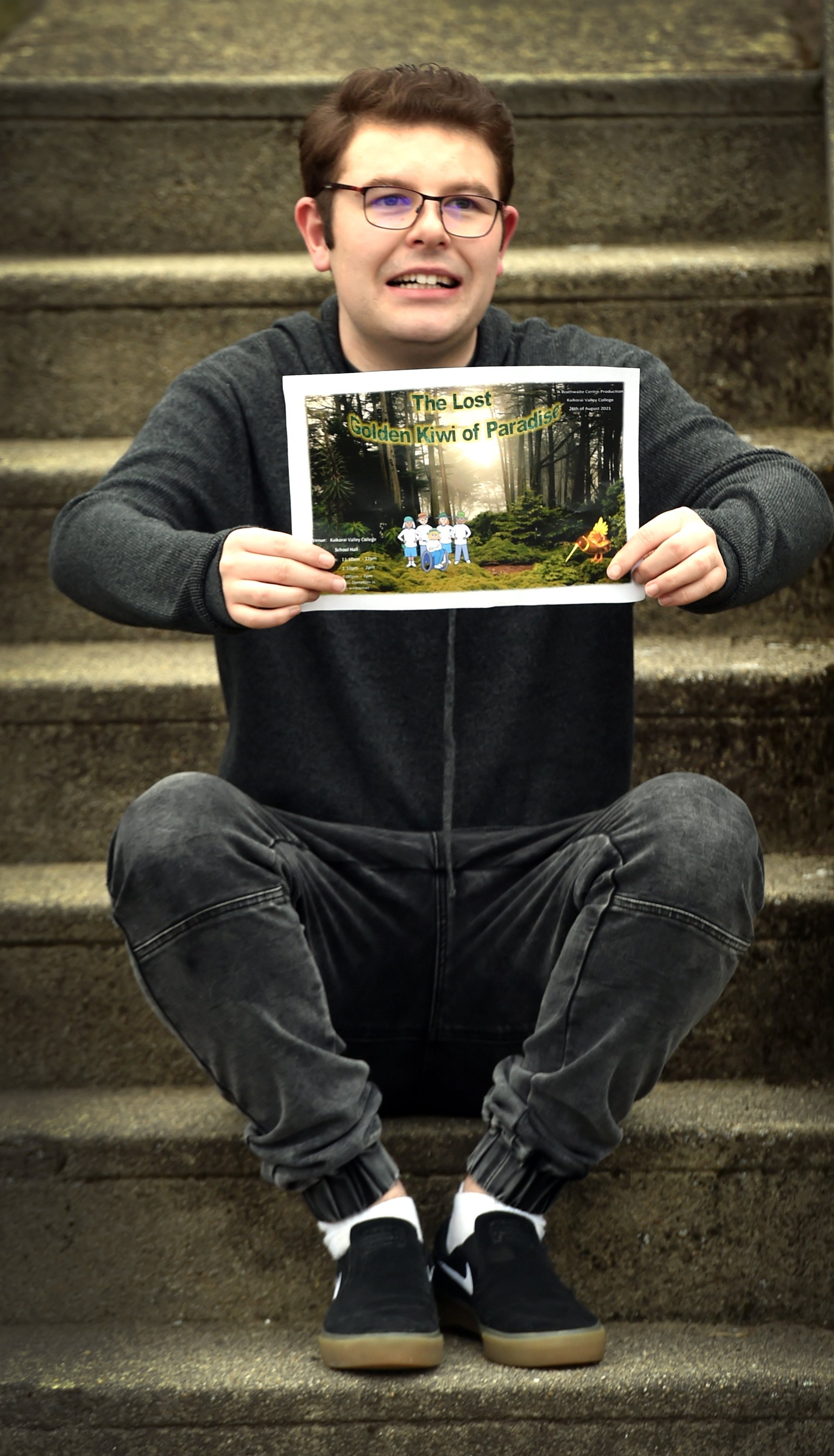 Showing a poster for the postponed Kaikorai Valley College special needs production is actor Cody...