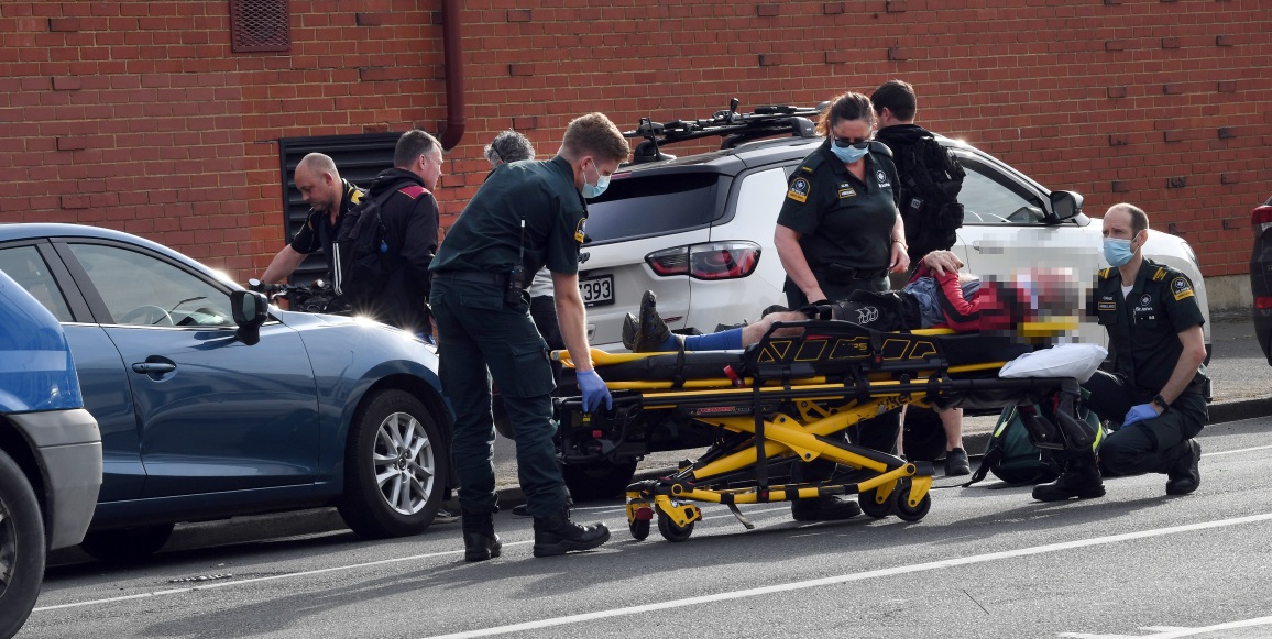 Emergency services with the injured person in St Andrew St this morning. Photo: Stephen Jaquiery