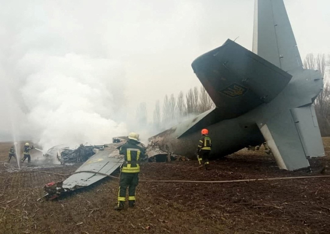 Rescuers work at the crash site of a Ukrainian Armed Forces' Antonov aircraft, which, according...