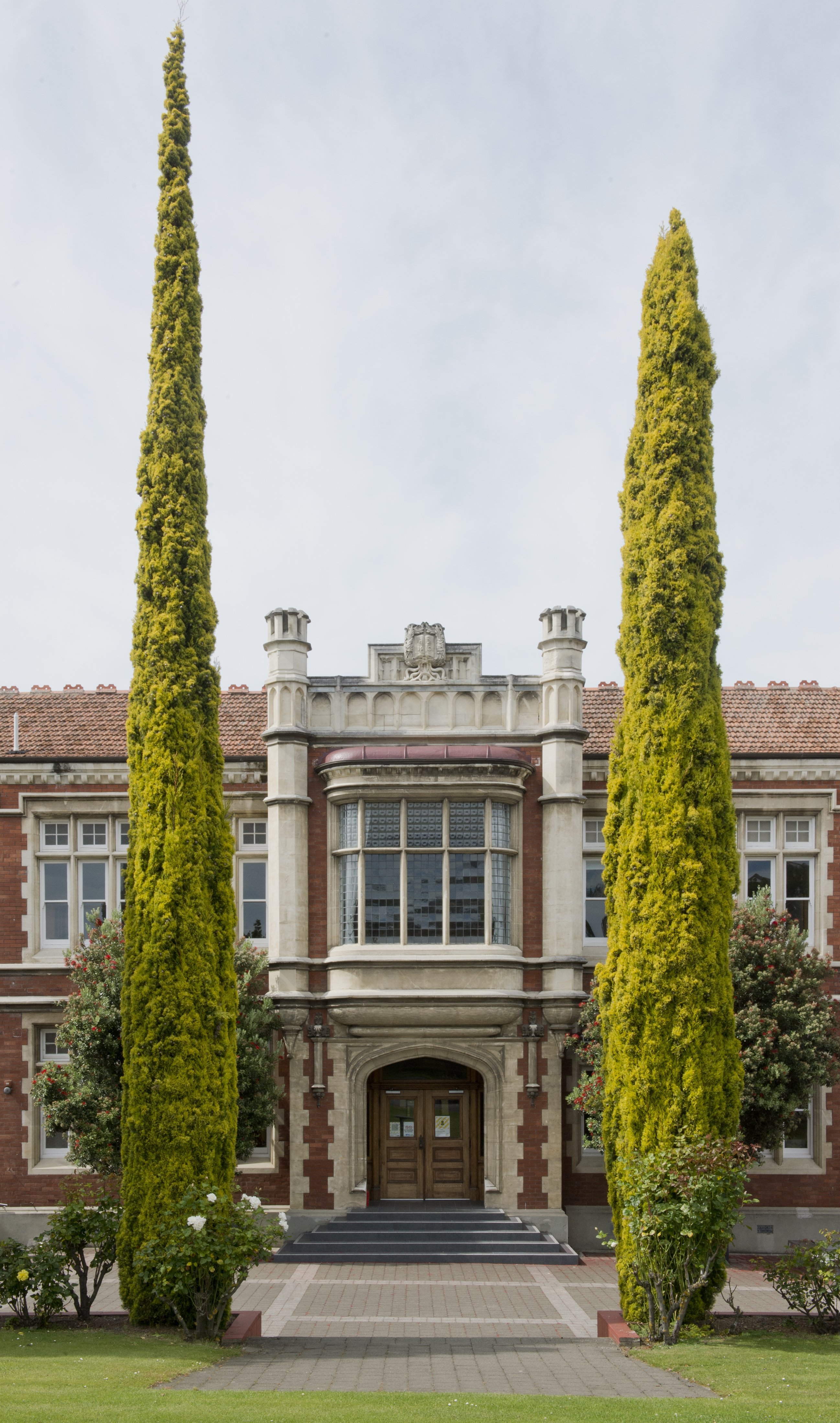 A couple of impressive Italian cypresses stand guard near a main entrance at Otago Girls’ High...