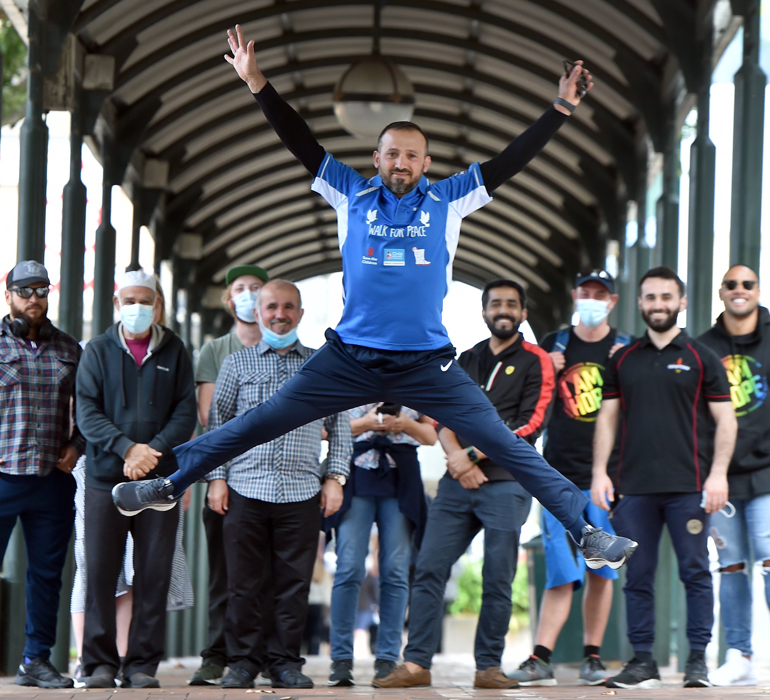 Surrounded by supporters in the Octagon, Temel Atacocugu is walking from Dunedin to Christchurch...