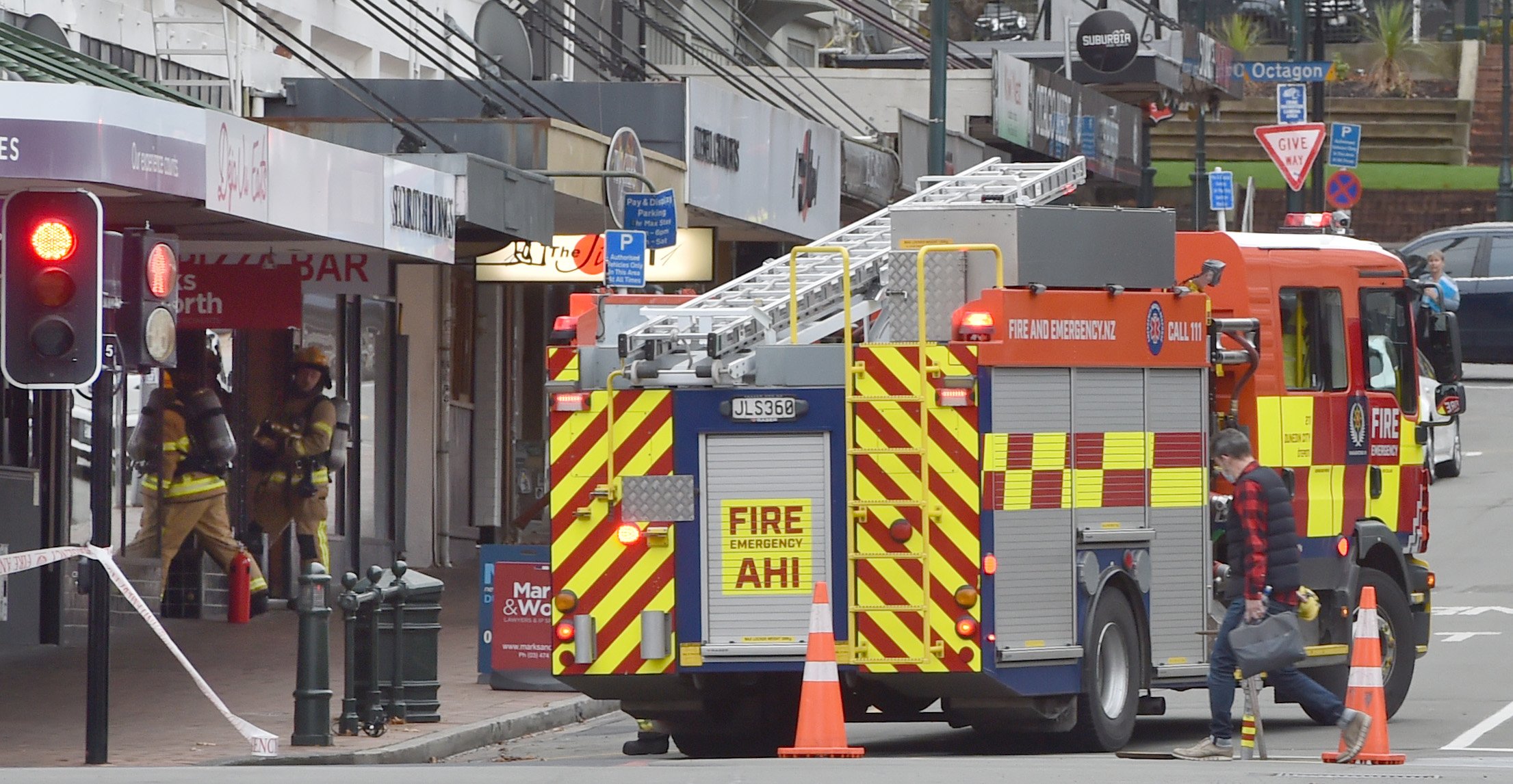 Firefighters check buildings in Lower Stuart St this morning. PHOTO: GREGOR RICHARDSON