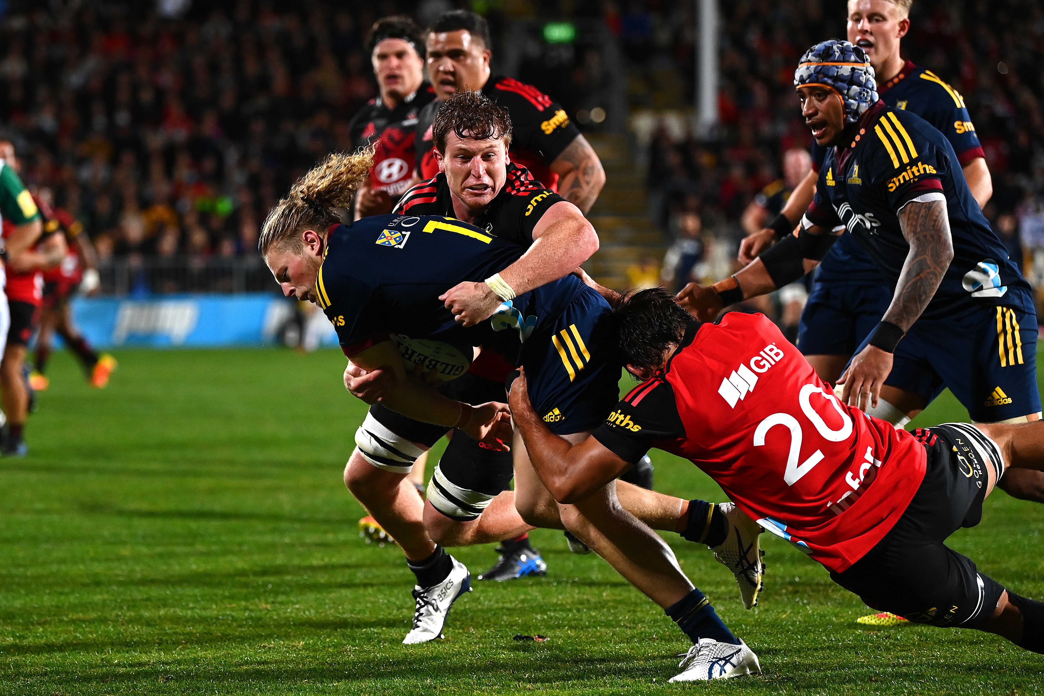 Crusaders players tackle Highlander Scott Gregory, who went on to score a try in Christchurch...