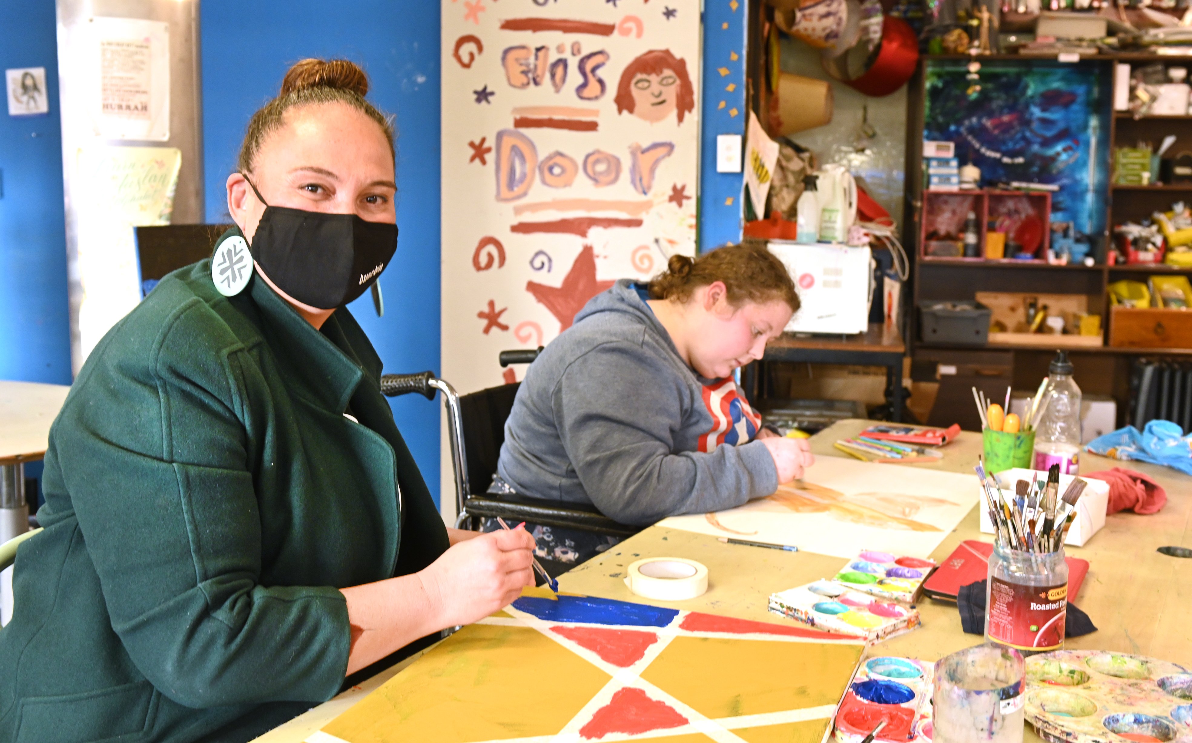 Minister for Social Development and Employment Carmel Sepuloni joins Tara Hook (20) at a painting...