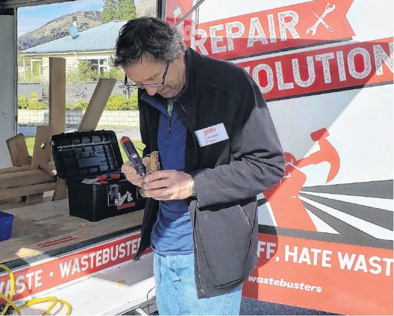 A volunteer fixer keeps another precious belonging in circulation at a repair event. PHOTO: ABBEY...