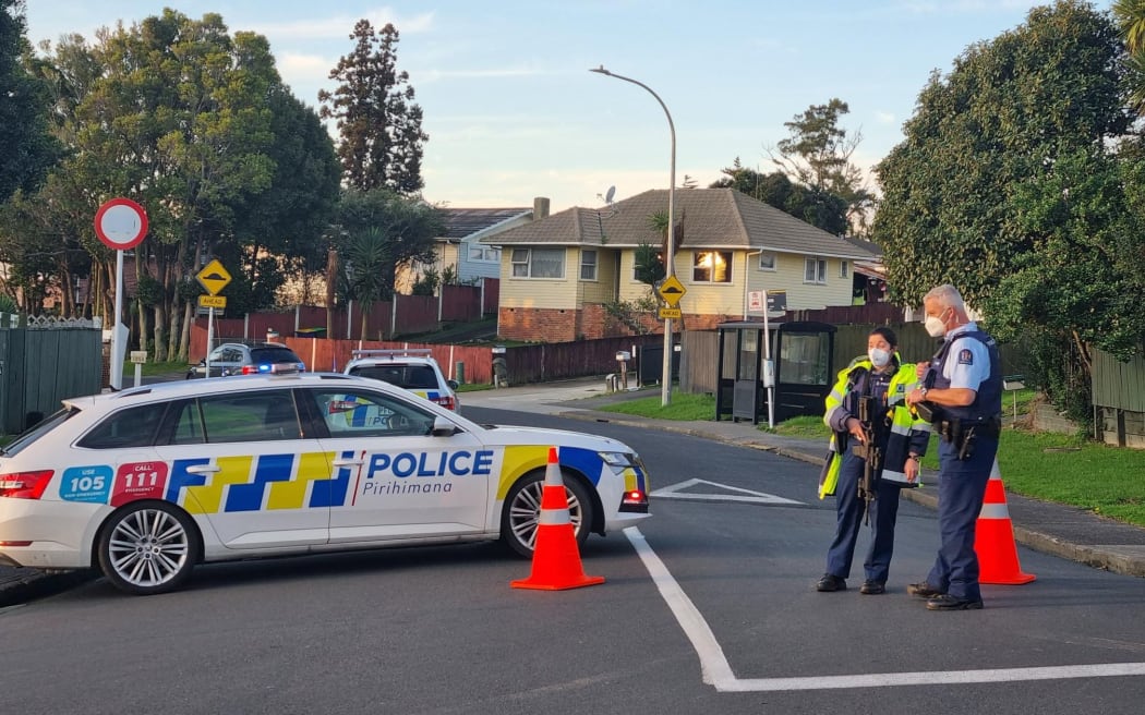 Police at a cordon near the scene in the West Auckland suburb of Glendene. Photo: RNZ 