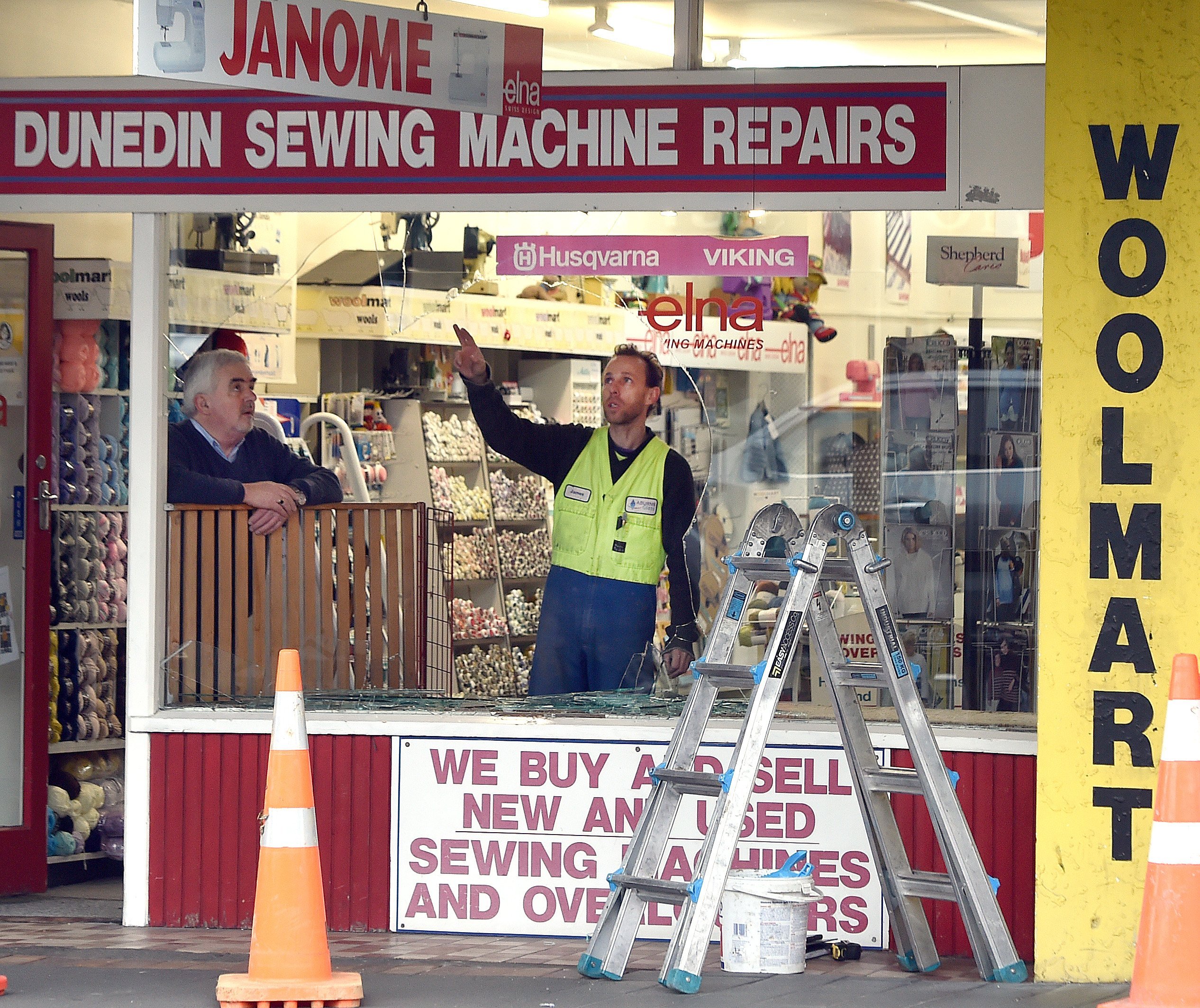 Dunedin Sewing Machine Repairs owner Mike McNulty watches as a glazier assesses  his South...