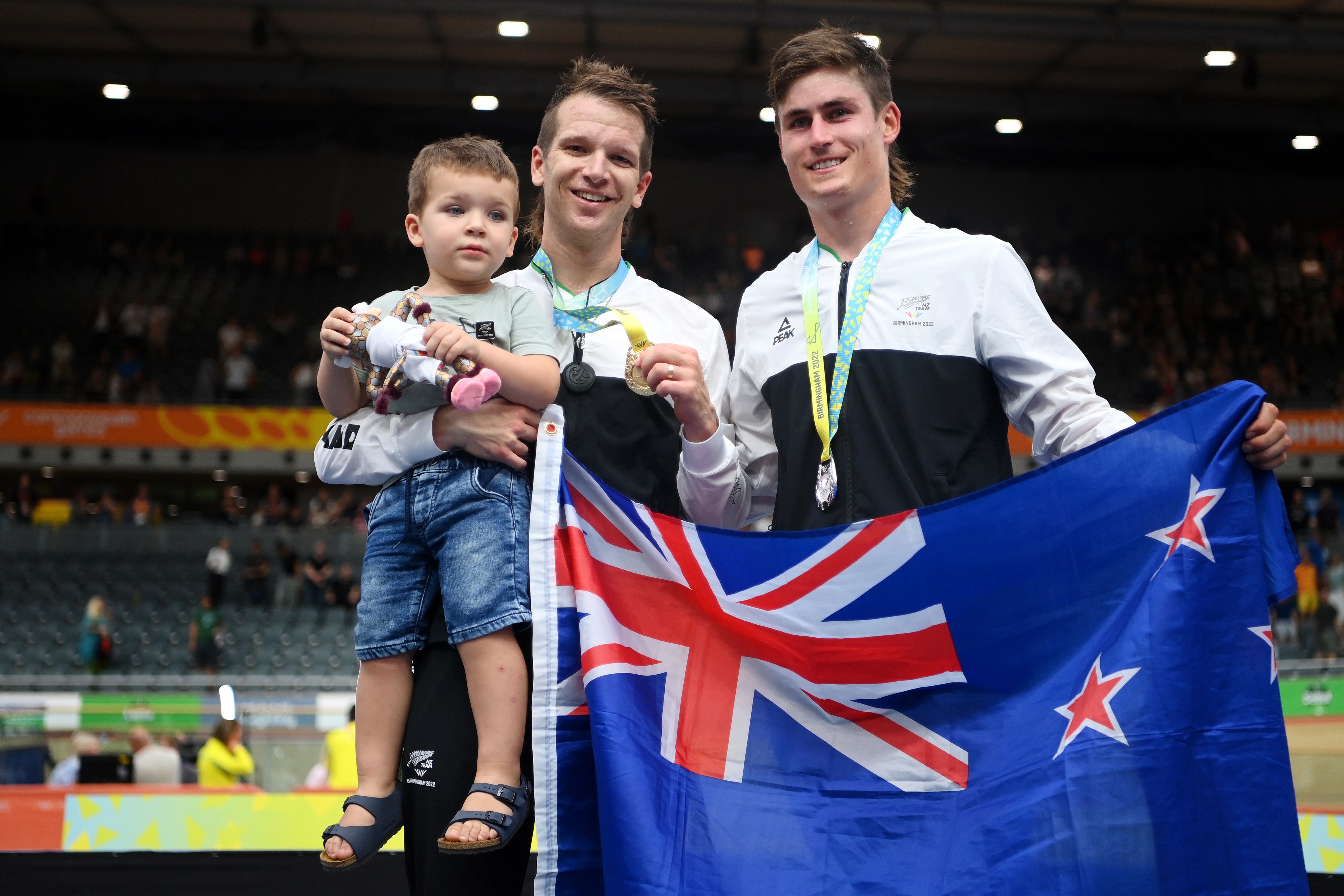 Aaron Gate with his son Axel and teammate and silver medalist Campbell Stewart. Photo: Getty Images