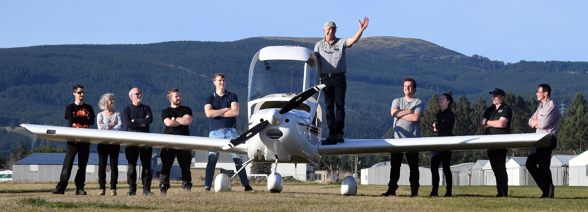 Test pilot Colin Chalmers gives a pre-flight wave to all those connected to the construction of...