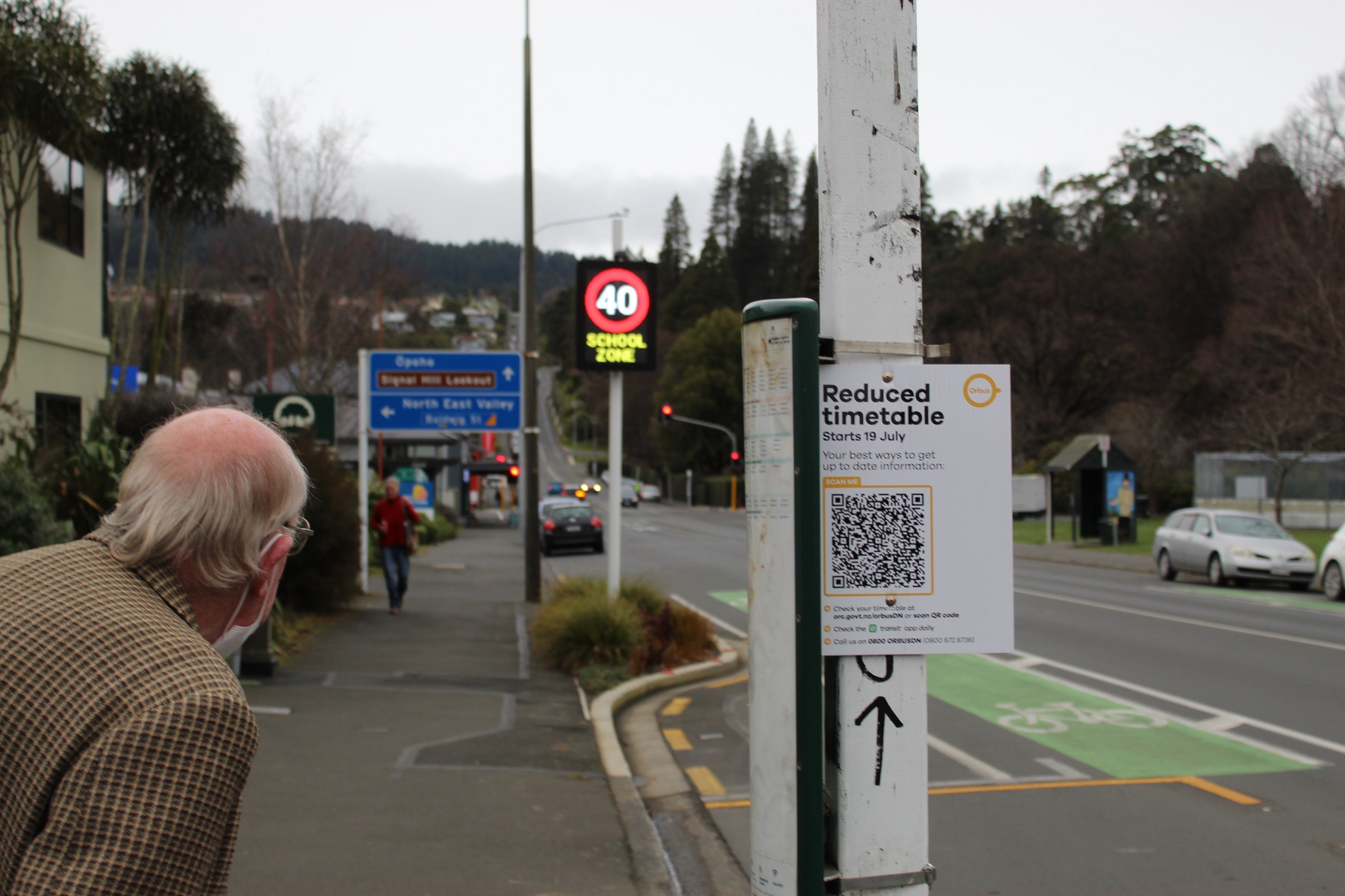 Don Shaw, of North Dunedin, peers along Bank St towards North Rd from a temporary bus stop. Photo...