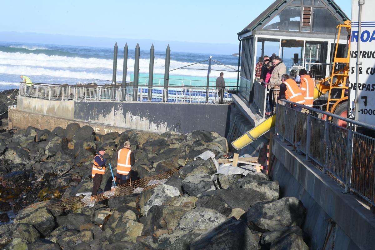 Contractors pour cement for new stairs beside the St Clair Hot Salt Water Pool in this June file...