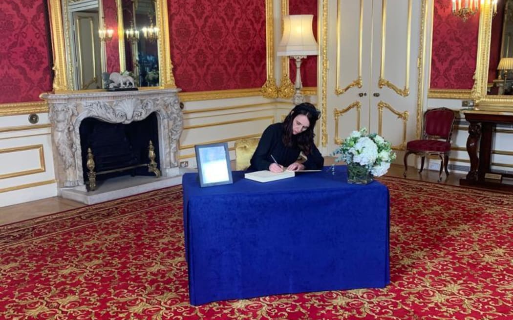 NZ Prime Minister Jacinda Ardern signing the official condolence book for Queen Elizabeth in London overnight. Photo: RNZ