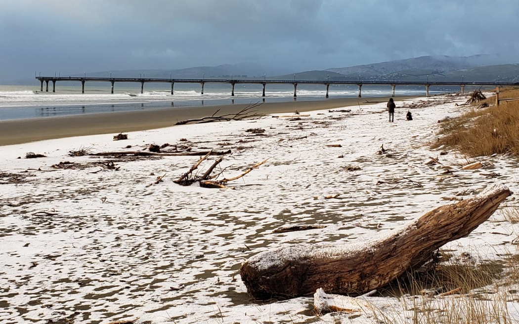 Snow on New Brighton beach, Christchurch, on Tuesday. Photo: Supplied/Emma Derrick