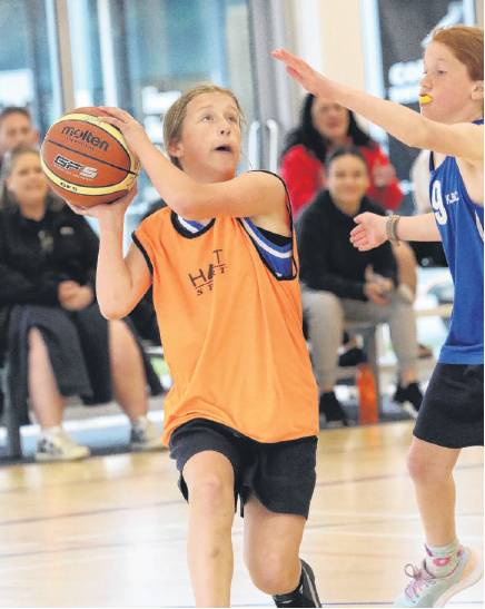 Shot away . . . Annabel Sutherland aged 10, of Clarkville School, tries for the hoop during her...