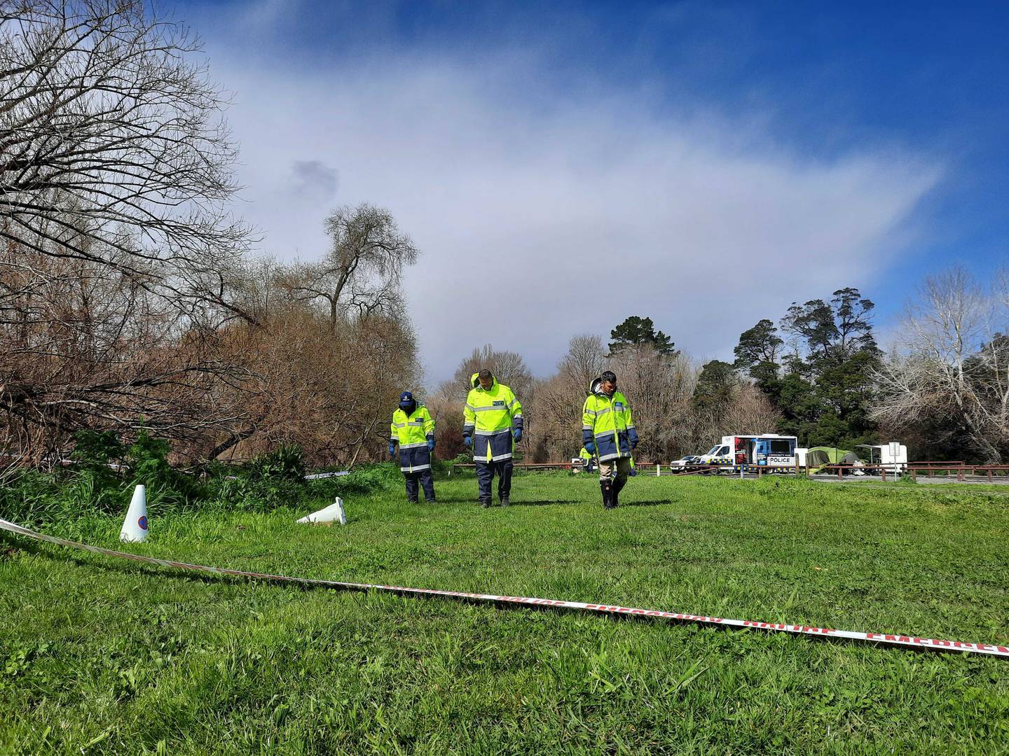 Police officers searching for evidence as they scour the River Rd Recreational Reserve three days...