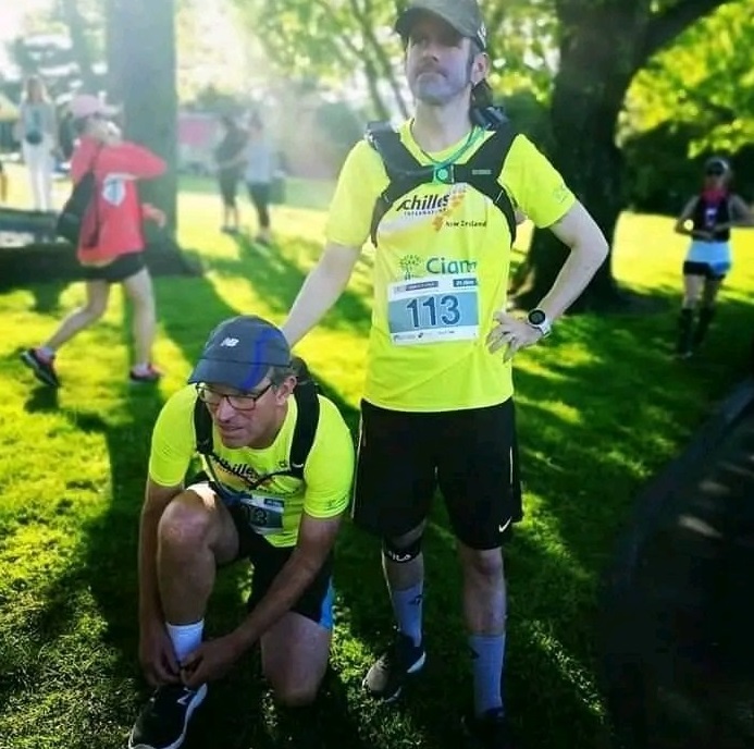 Mike Asmussen (right), who has a visual impairment, and guide runner Mark Boon, prepare for the...