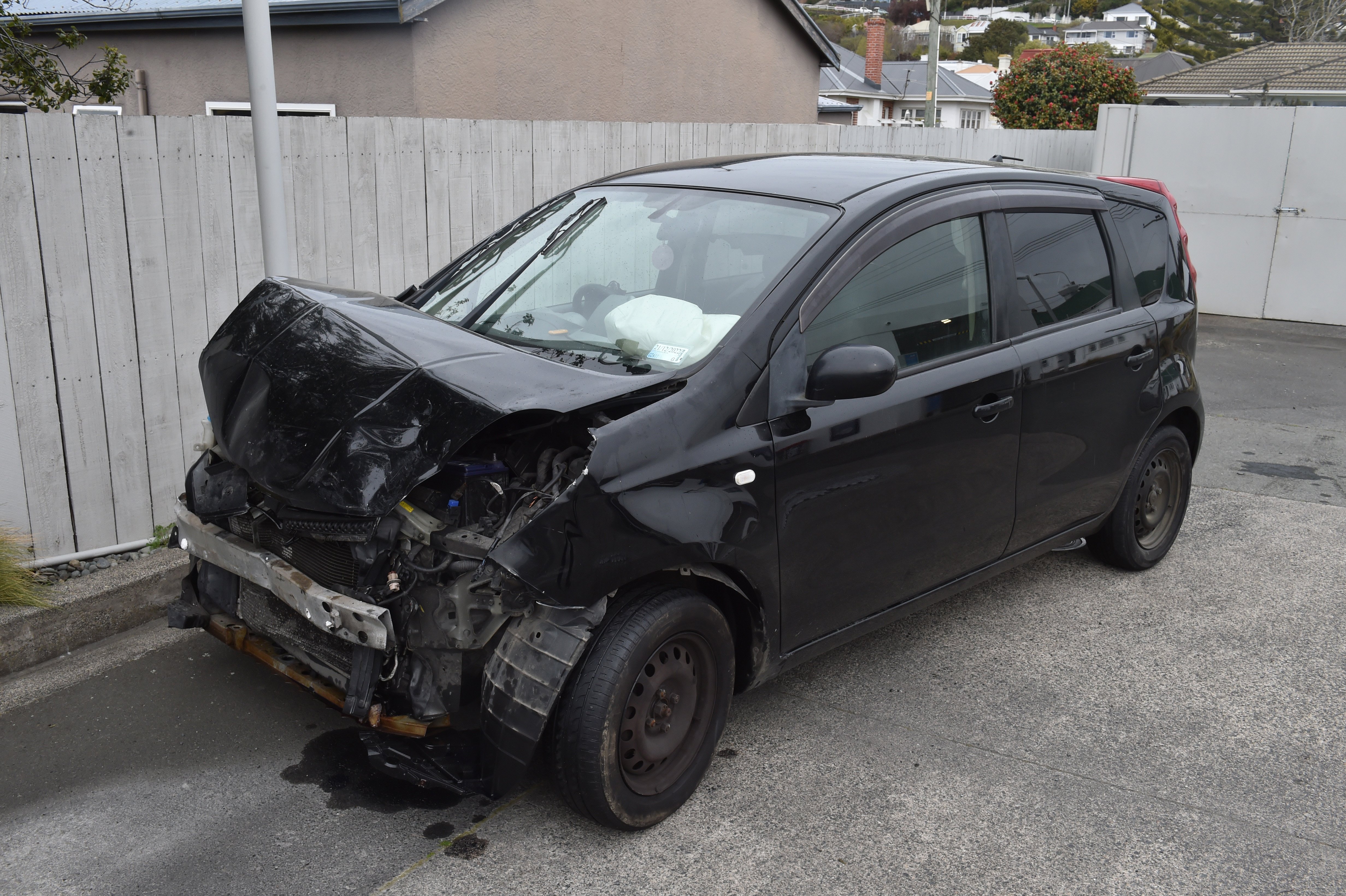 One of the damaged cars sits on the forecourt of the Mobil petrol station in Surrey St. PHOTO:...