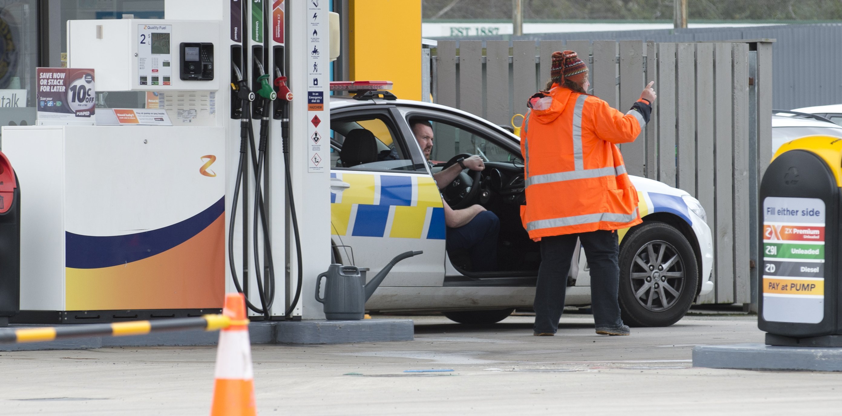 A police officer speaks to a witness at Z Energy Green Island in the aftermath of a disorder...