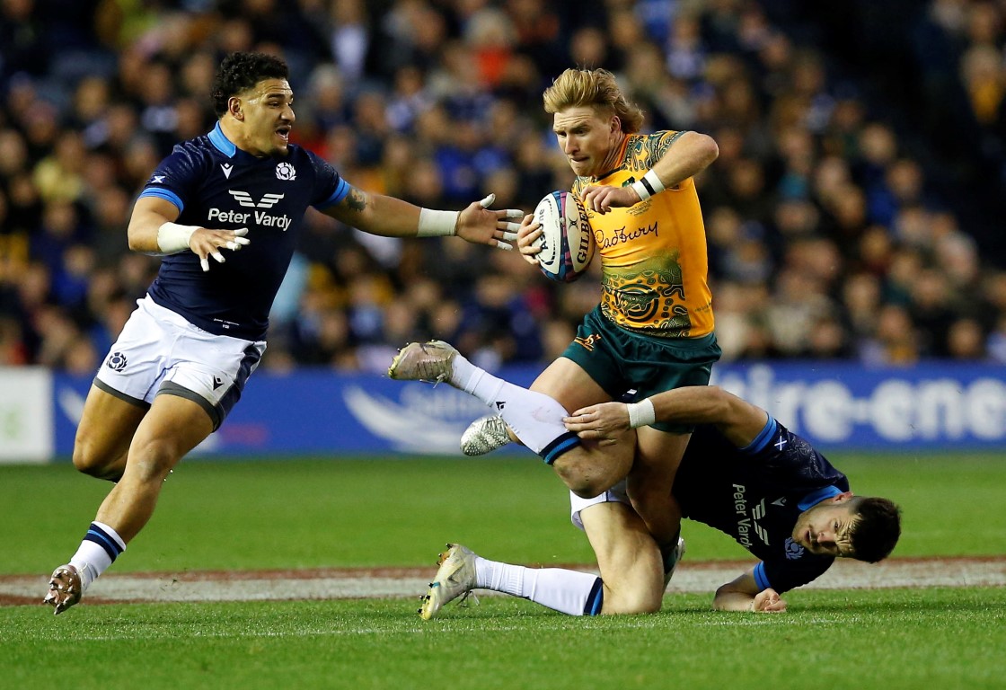 Australia's Tate McDermott runs the ball up against Scotland. Photo: Reuters