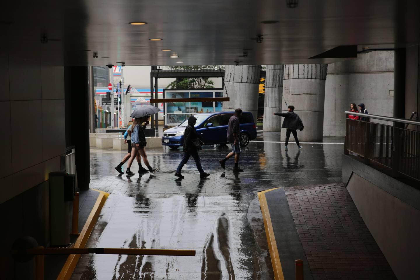 People walking through rainy Auckland.