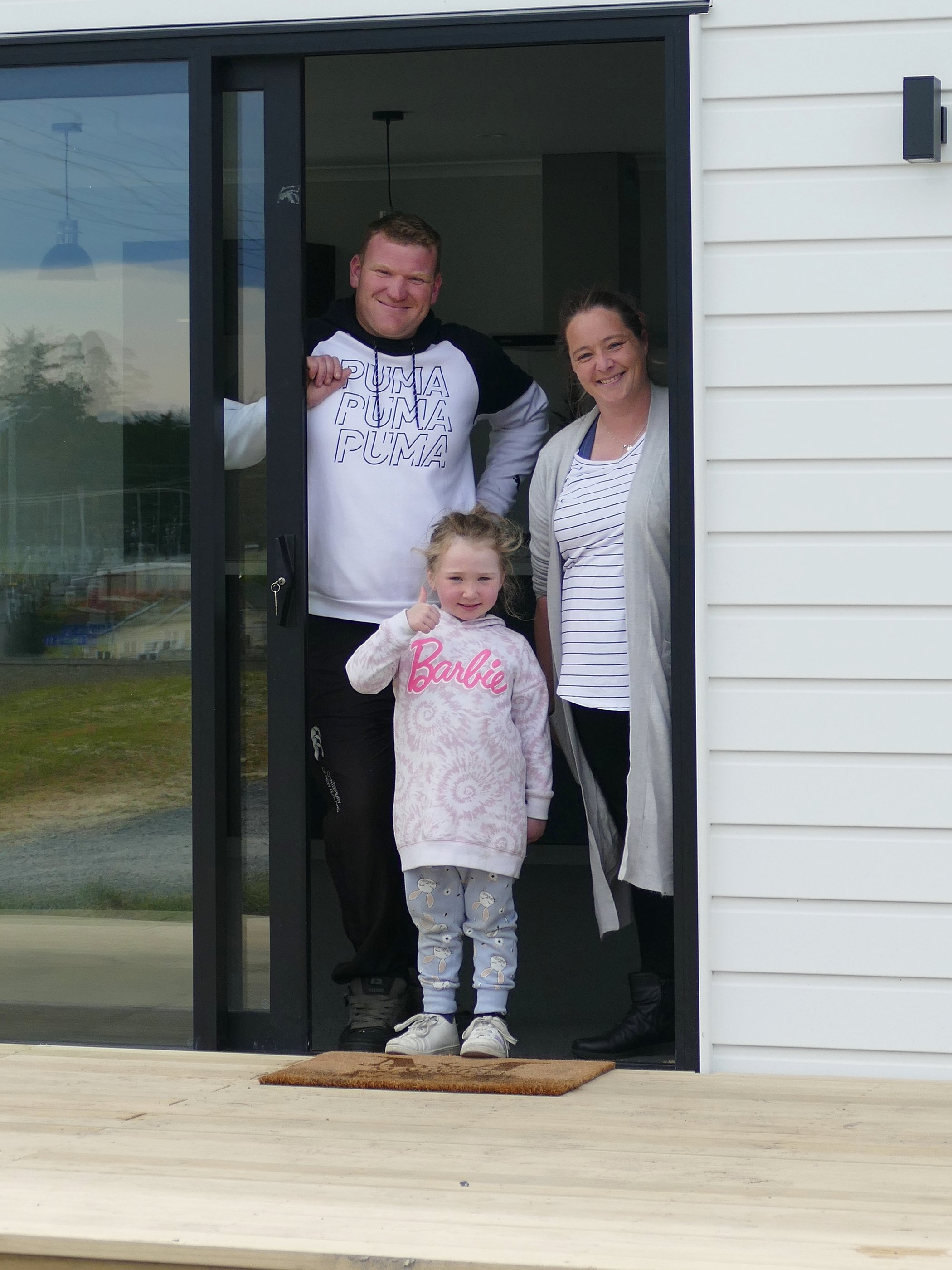 Maguire family members Fleur, Bradon and Myah (5) celebrate the completion of their new Exmouth...